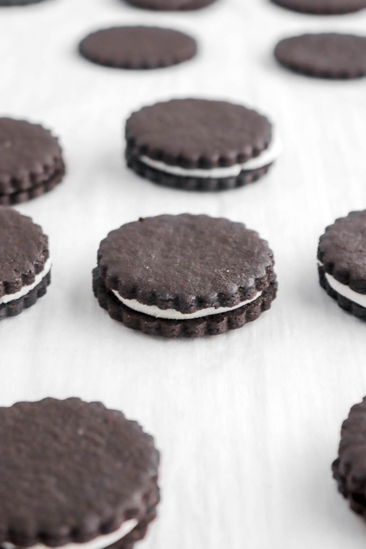 close up of oreos on parchment paper.
