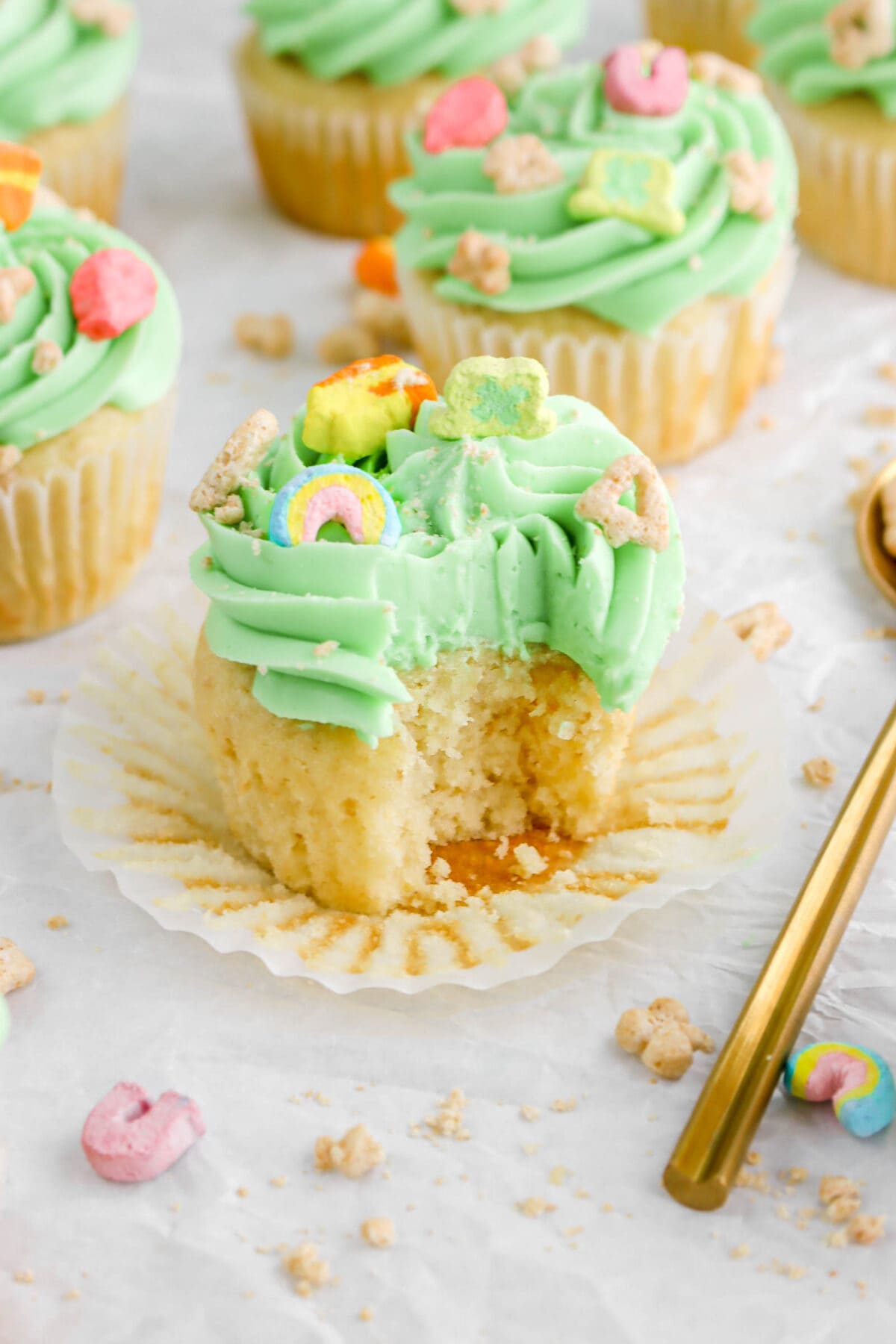 angled close up of lucky charms cupcake with bite missing.