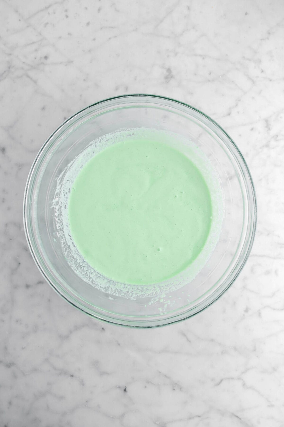 green milk mixture in glass bowl.