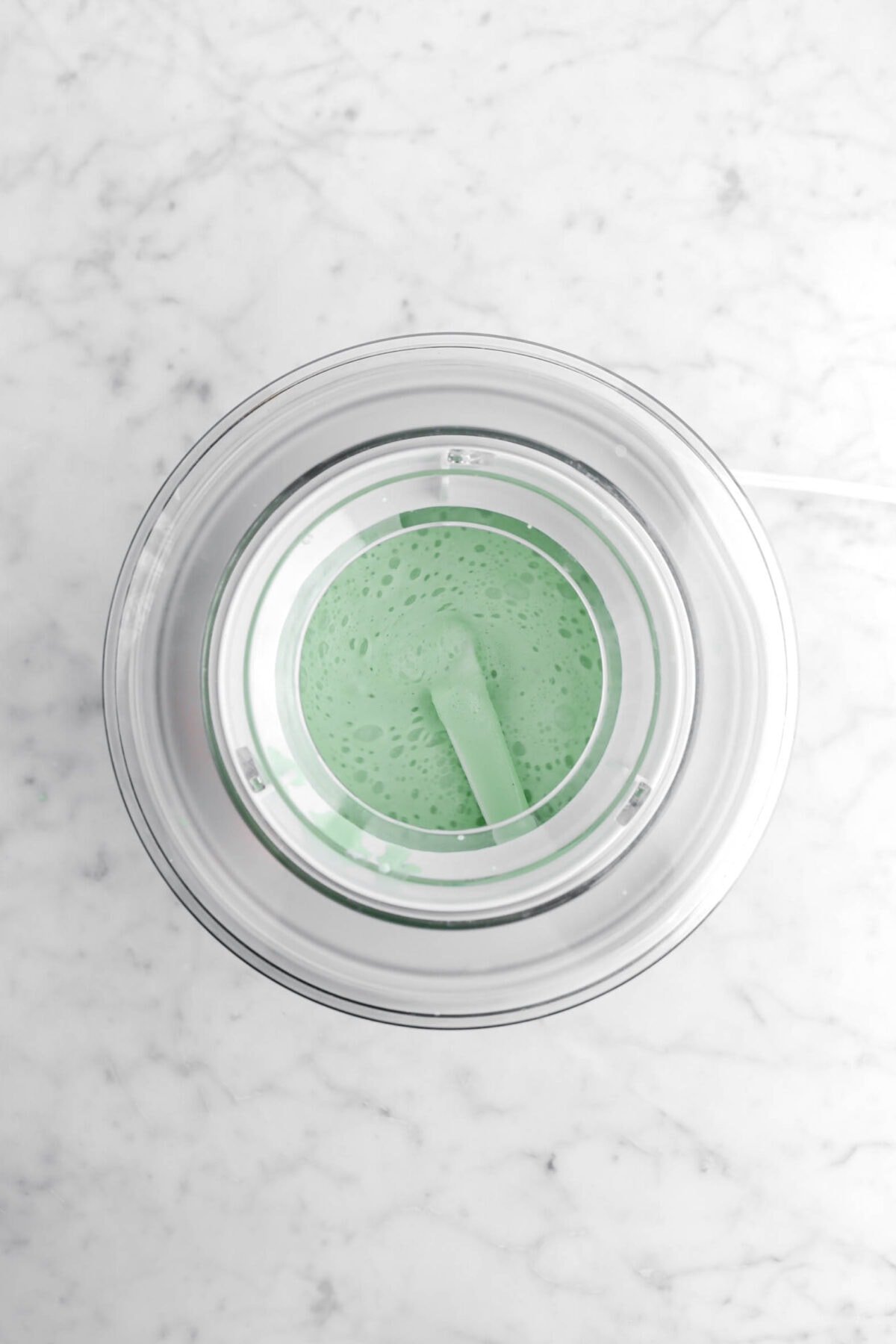 green milk mixture in ice cream machine.