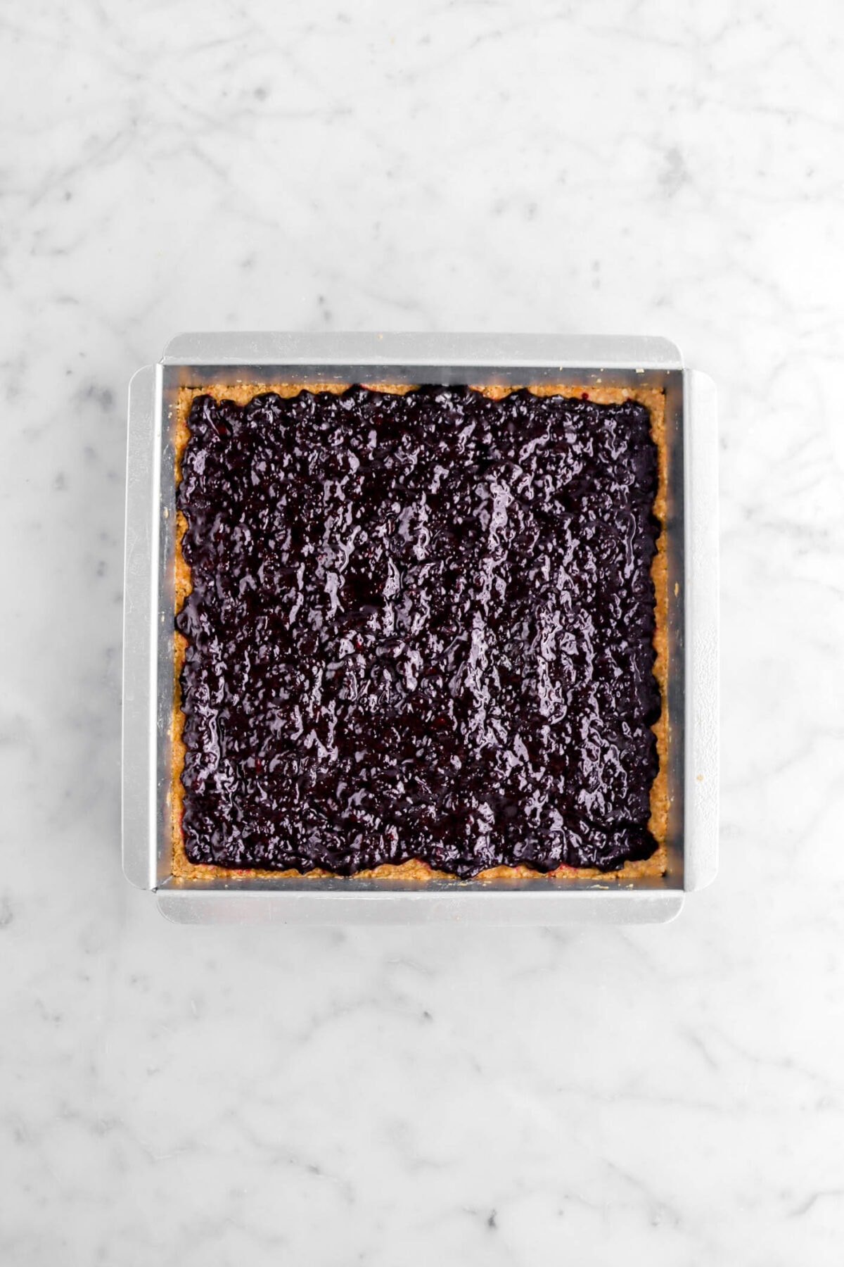 blueberry jam spread across par-baked crust.