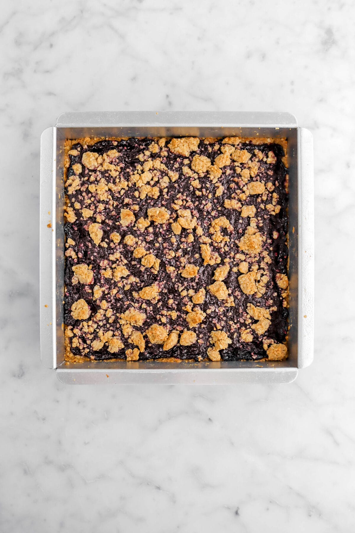 baked blueberry crumble bars in square pan.