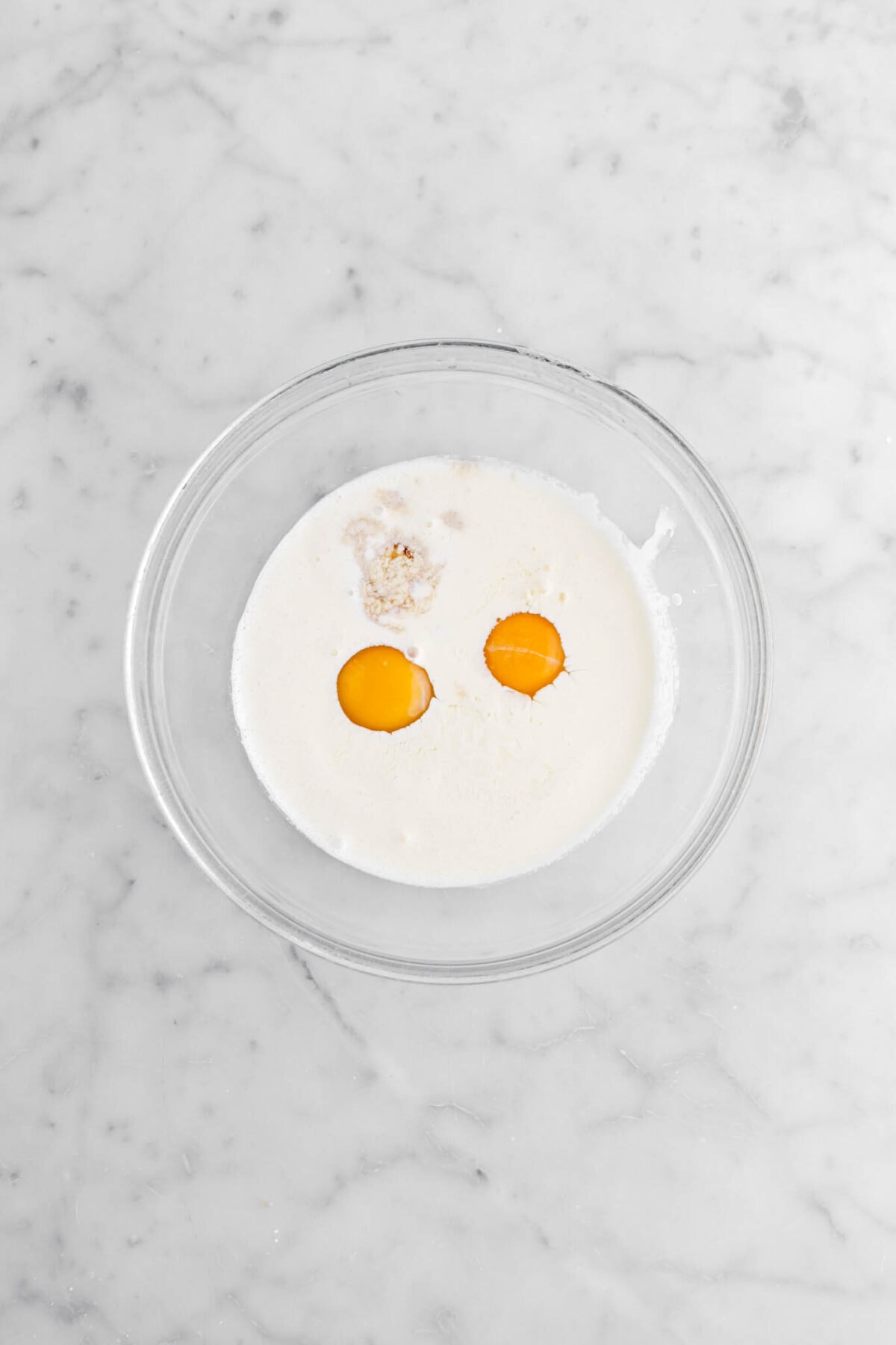 eggs, cream, and vanilla in glass bowl.