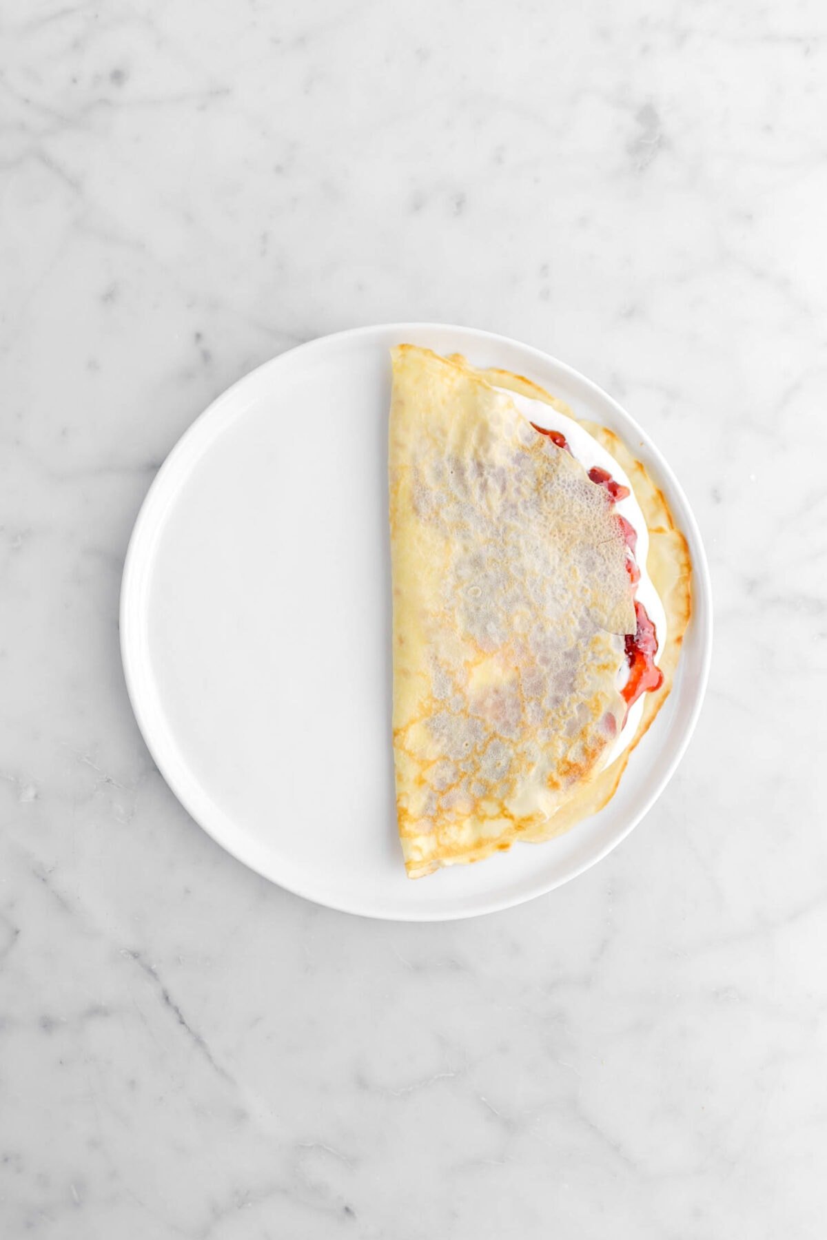 crepe folded over cream and jam.