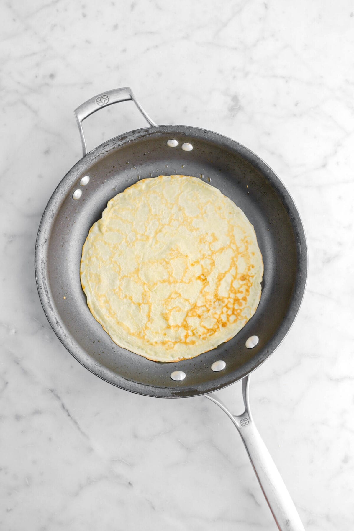 cooked crepe in non-stick skillet.