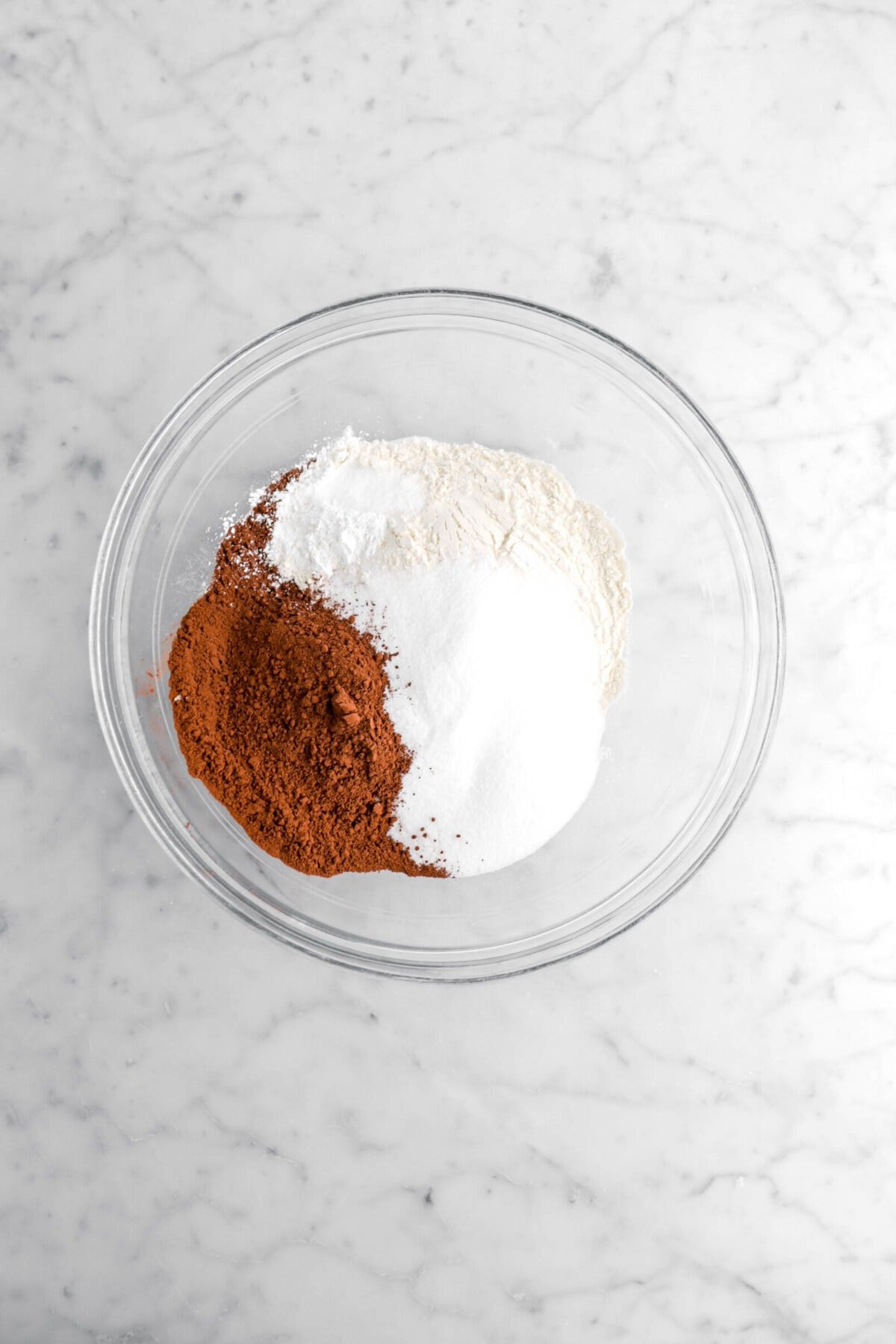 cocoa powder, sugar, flour, baking powder, and salt in glass bowl.