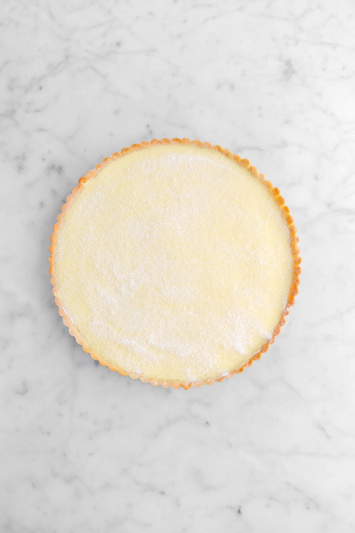 granulated sugar coating top of custard in tart shell.