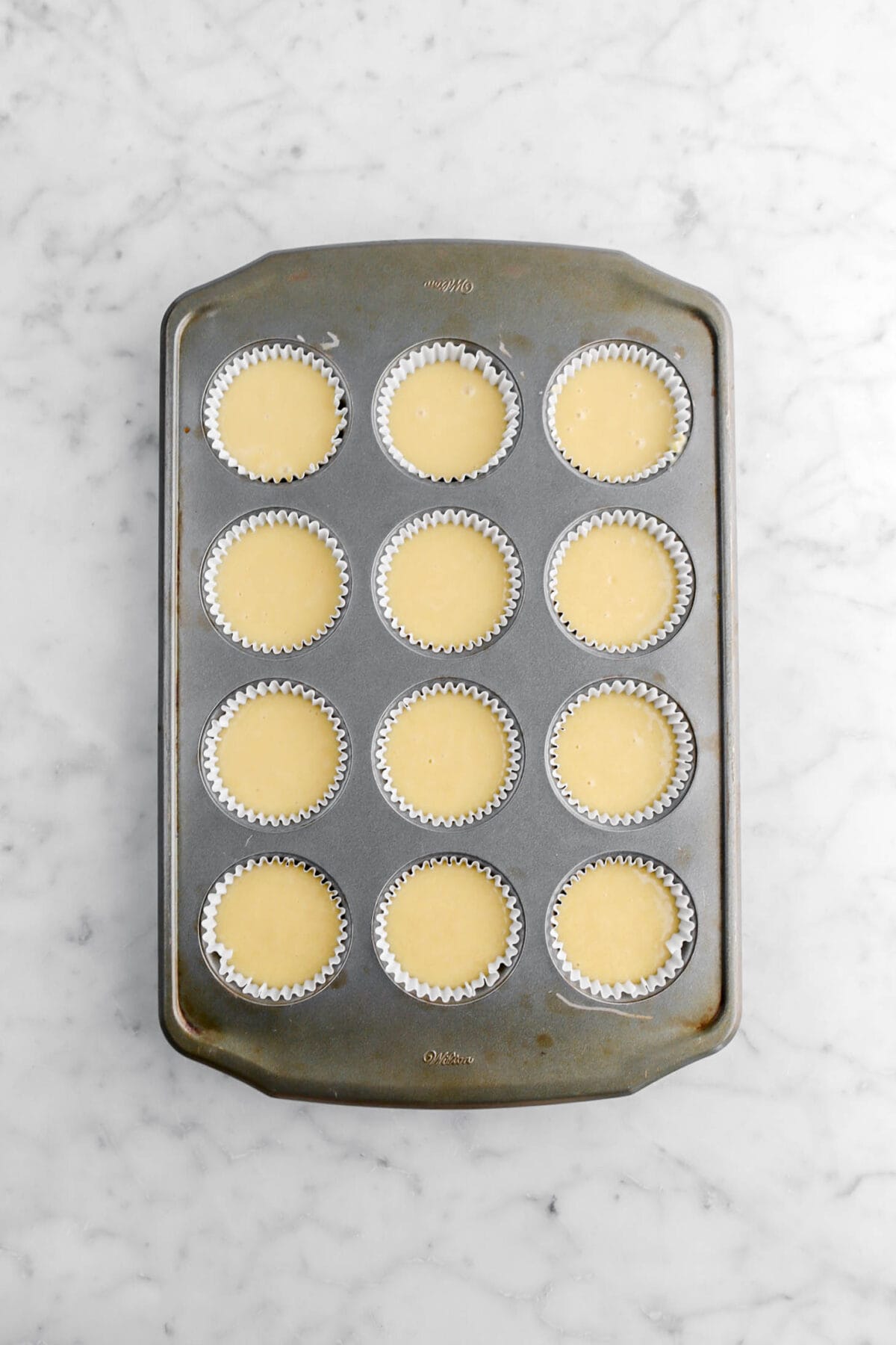 cake batter in lined cupcake pan.