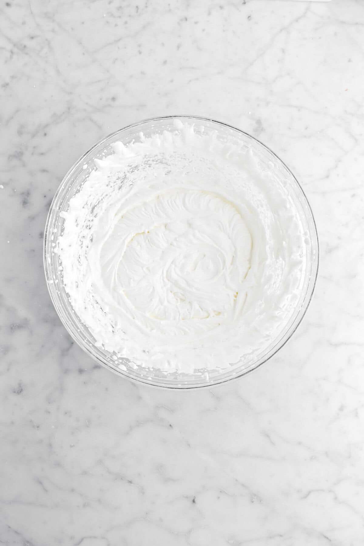 whipped cream in glass bowl.