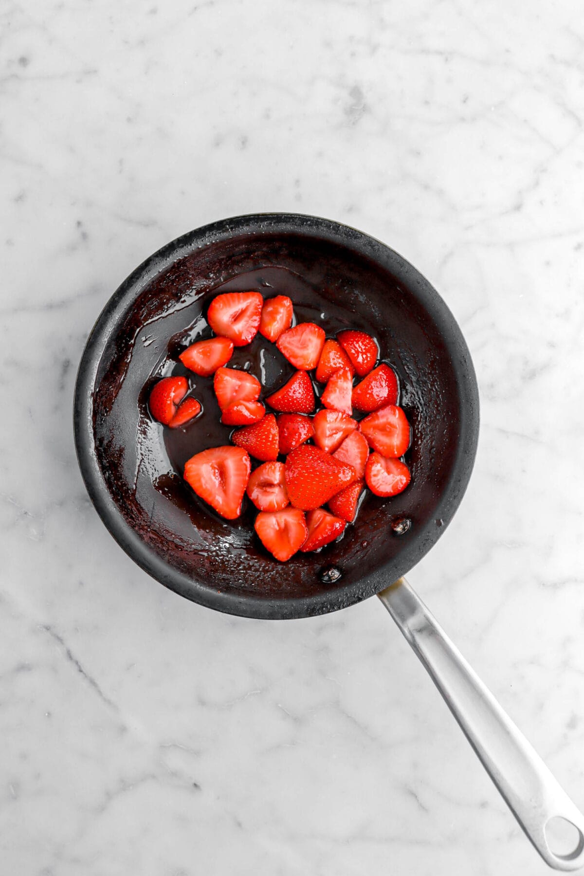 Sautéed strawberries in small skillet.