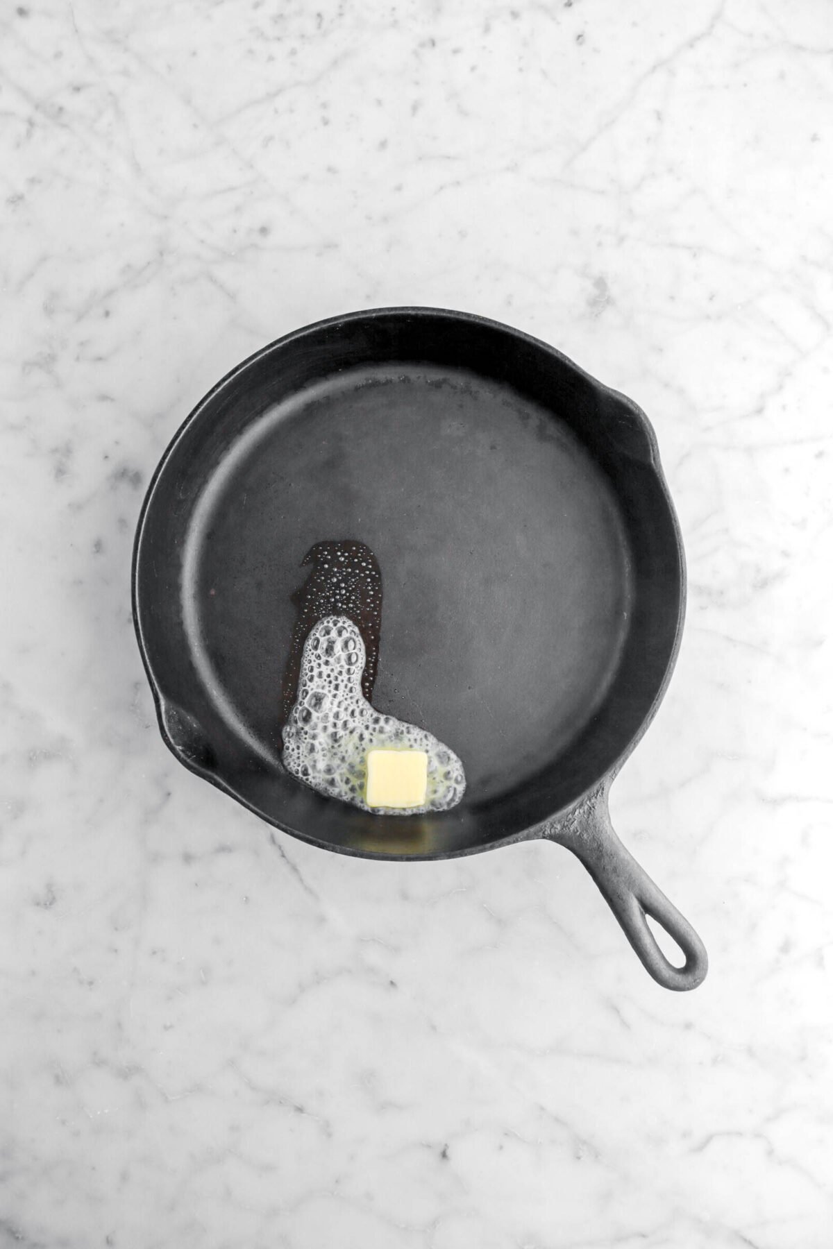 butter added to hot cast iron skillet.