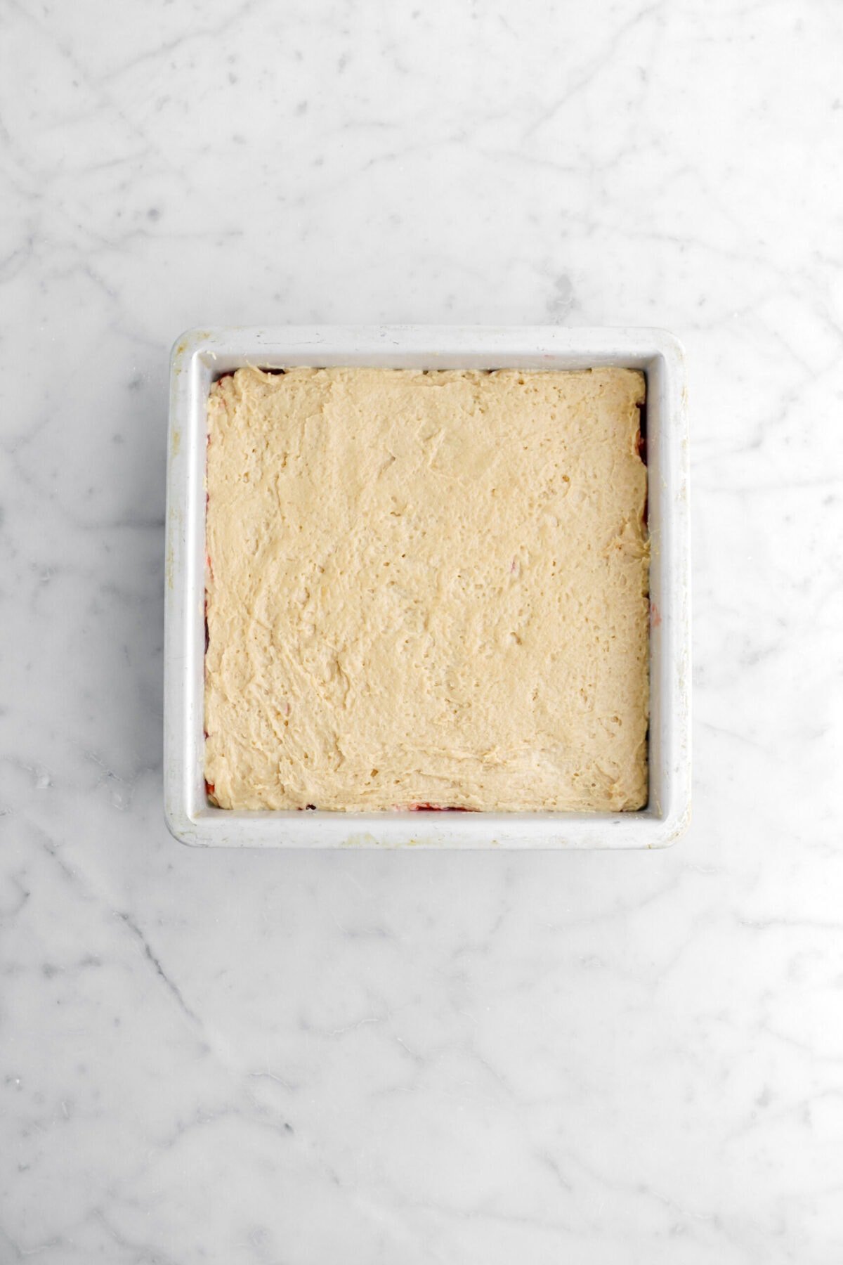 peanut butter cake batter in square pan.