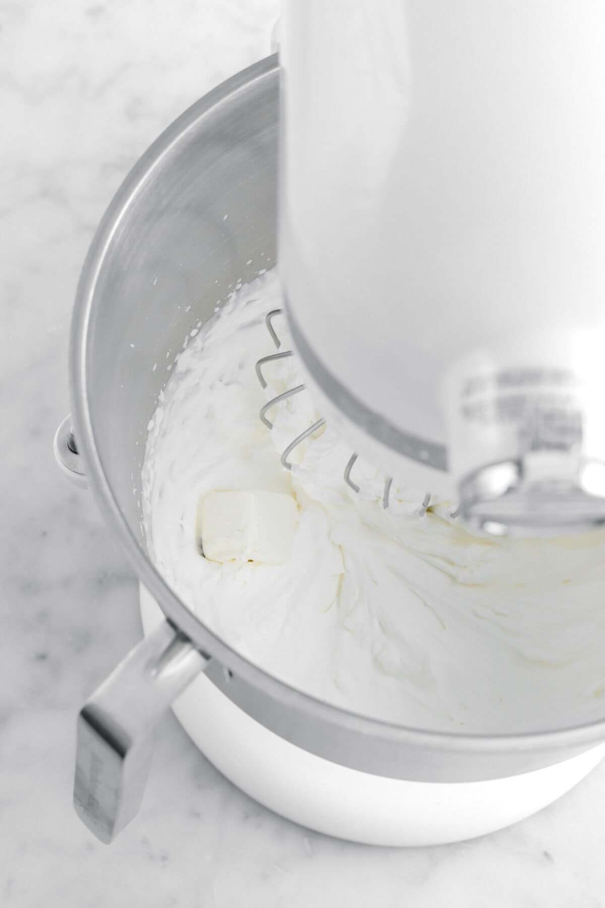 cube of cream cheese in stand mixer.