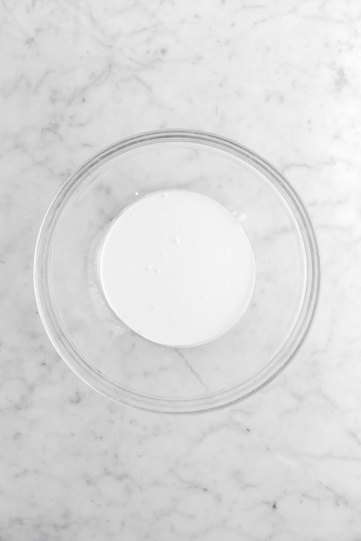 heavy cream in glass bowl.