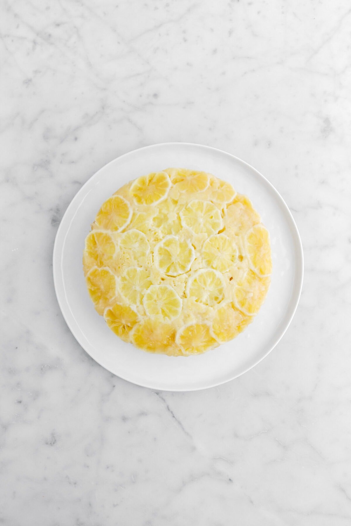 lemon upside down cake on white plate.