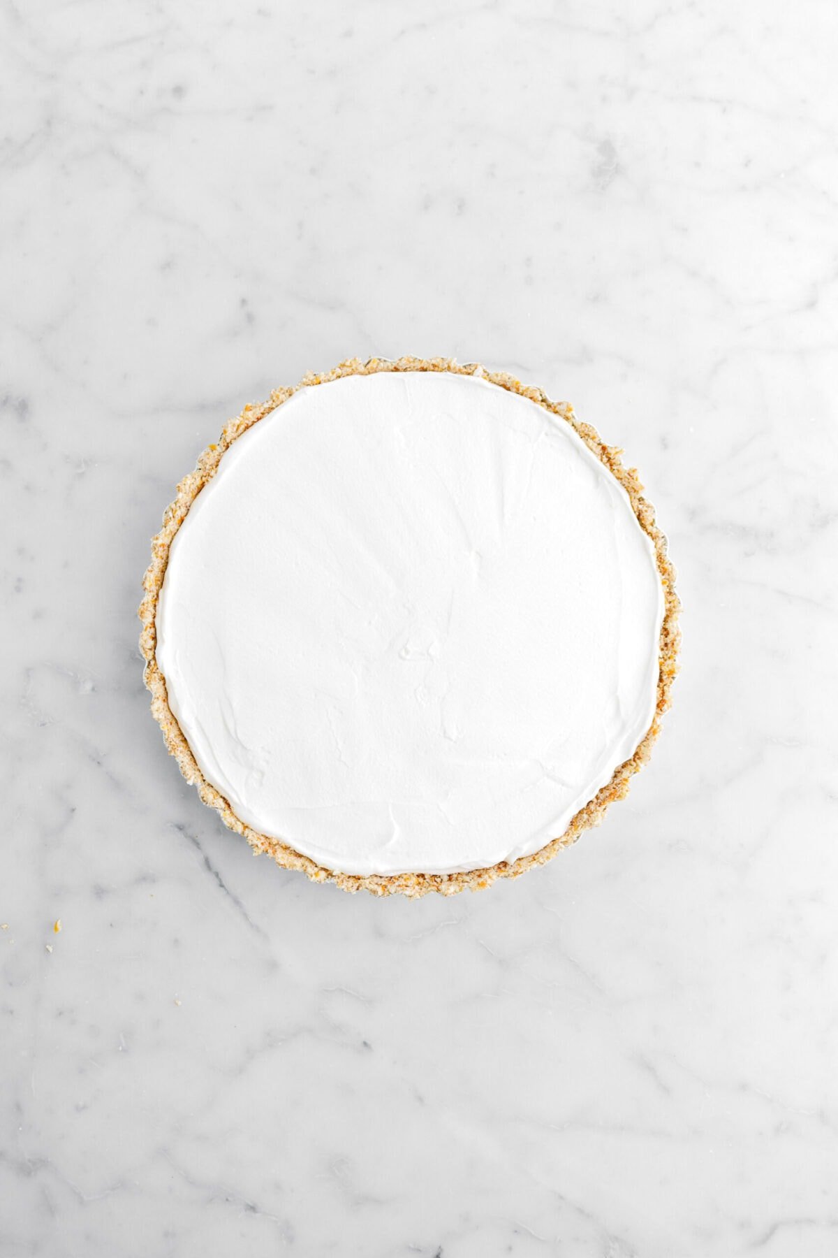 whipped cream spread evenly in tart crust.