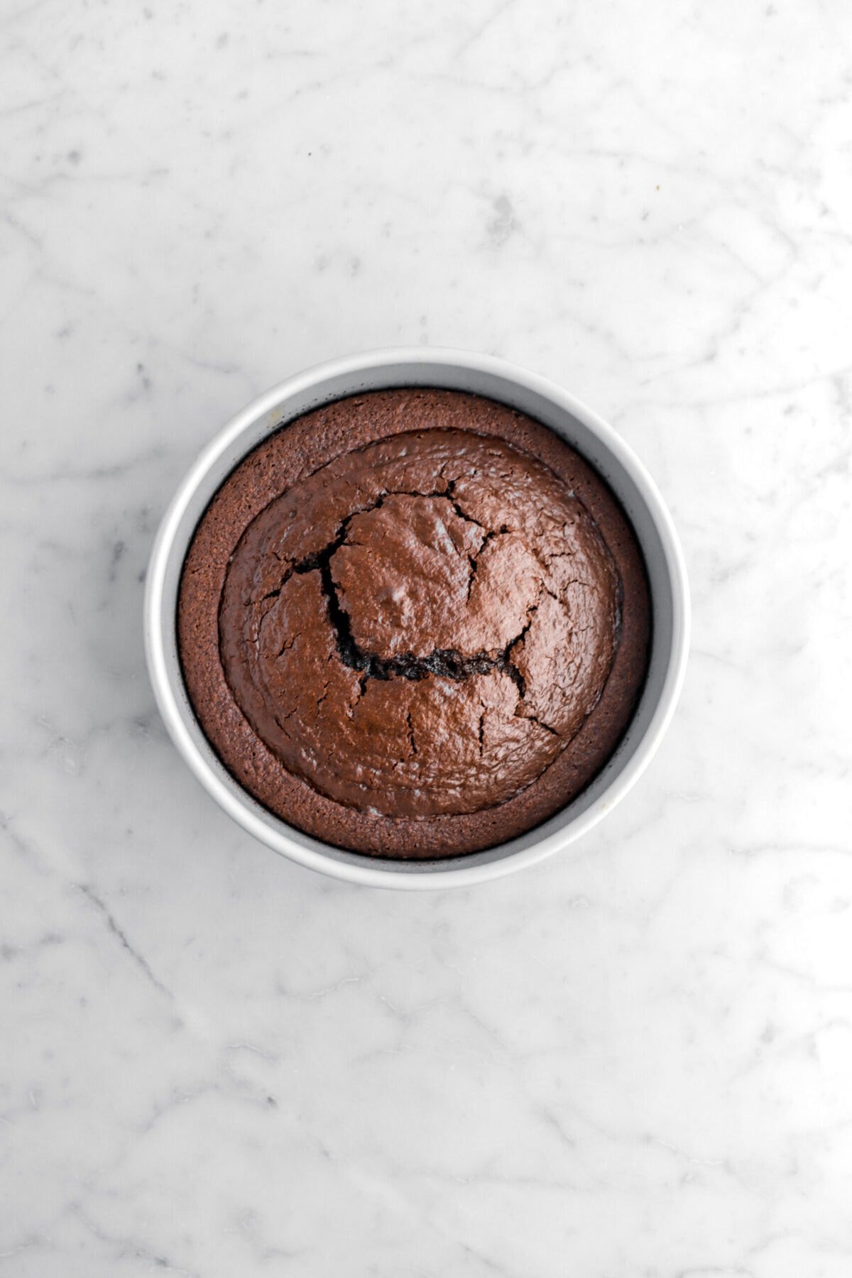baked chocolate cake in round pan.