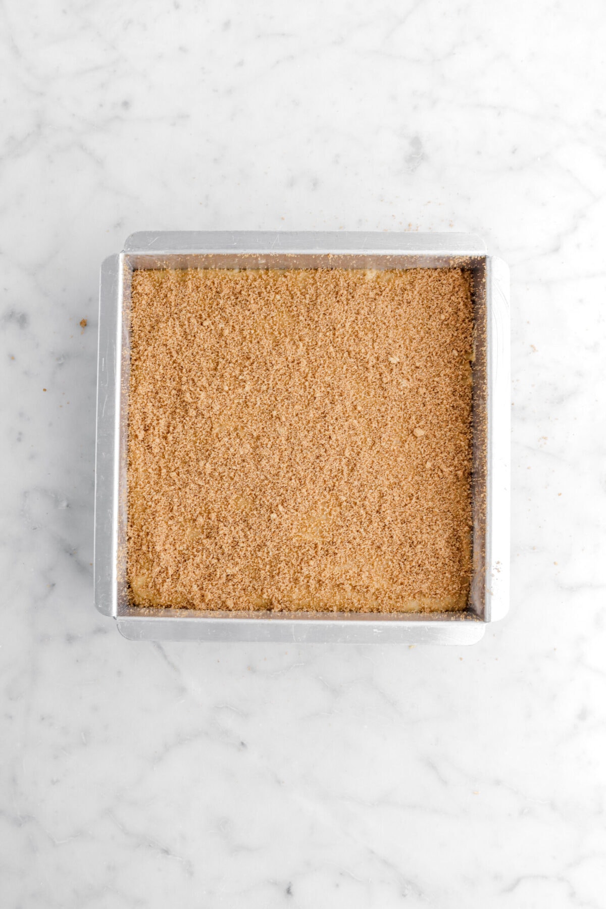 blondie batter in square pan with cinnamon sugar on top.