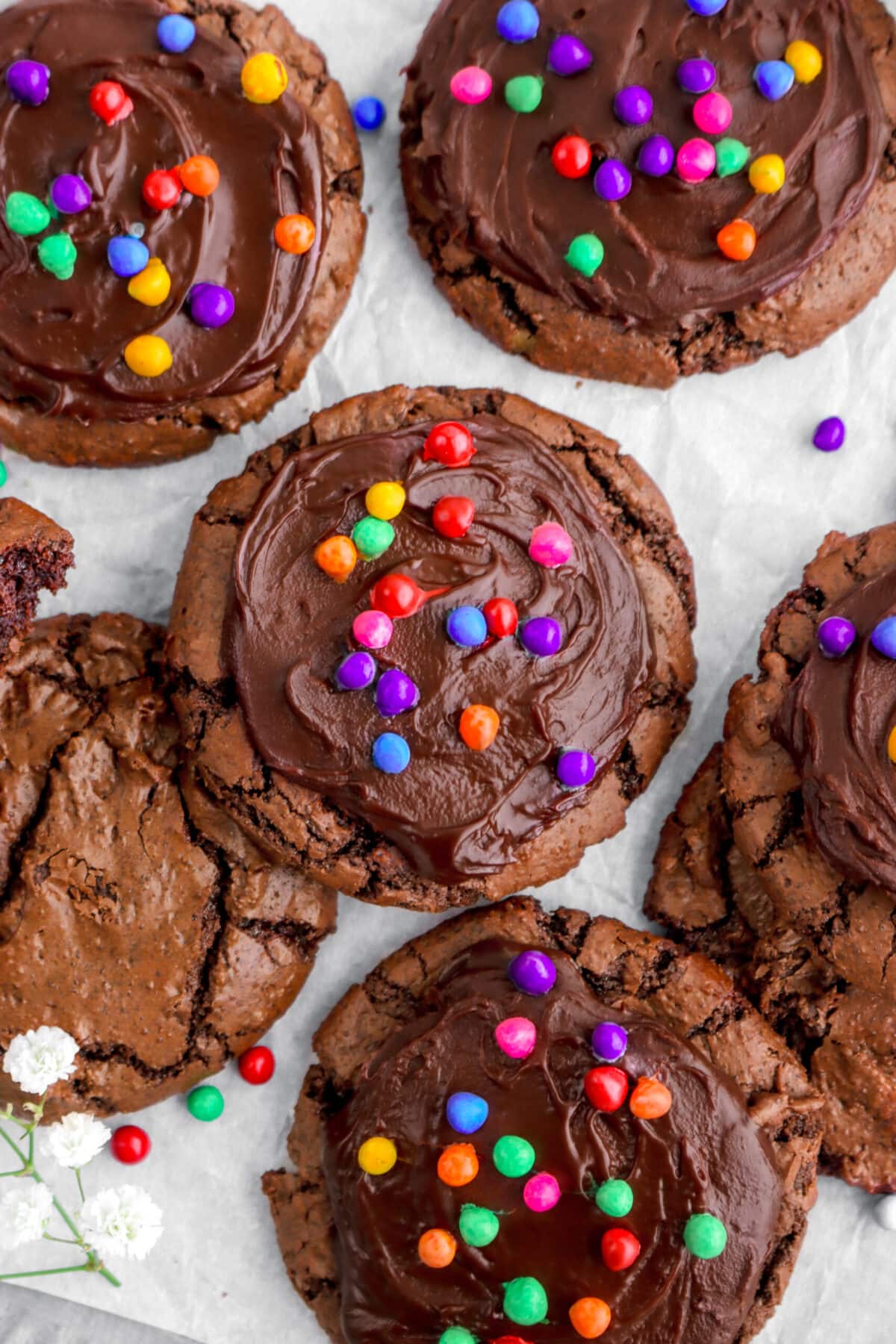 close up overhead shot of cosmic brownie cookies on parchment paper.