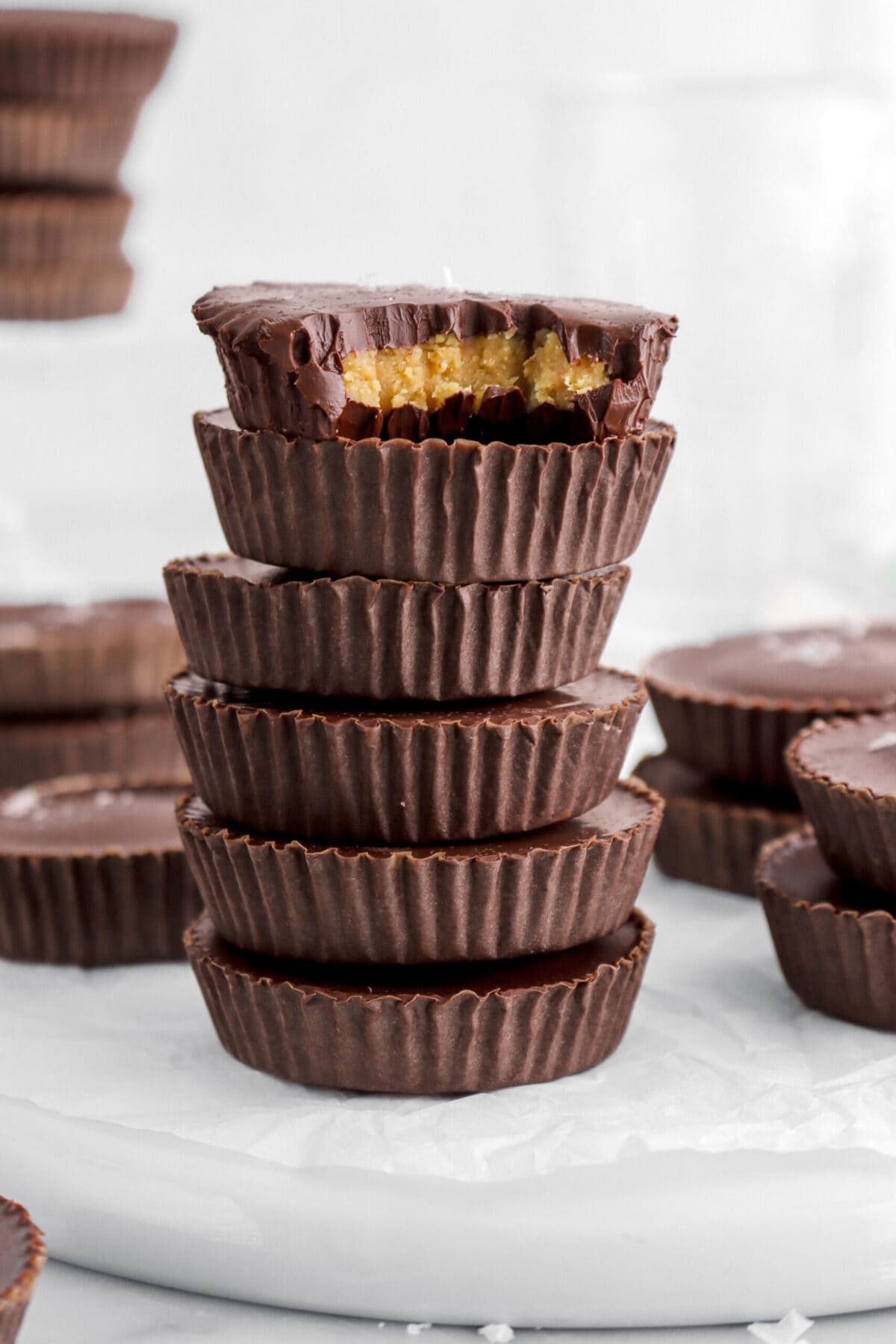six stacked peanut butter cups with top candy missing a bite.