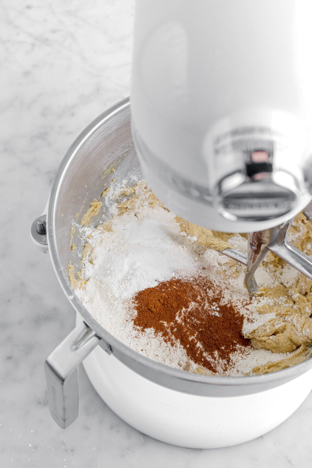 flour, cinnamon, baking powder, baking soda, and salt added to butter mixture.