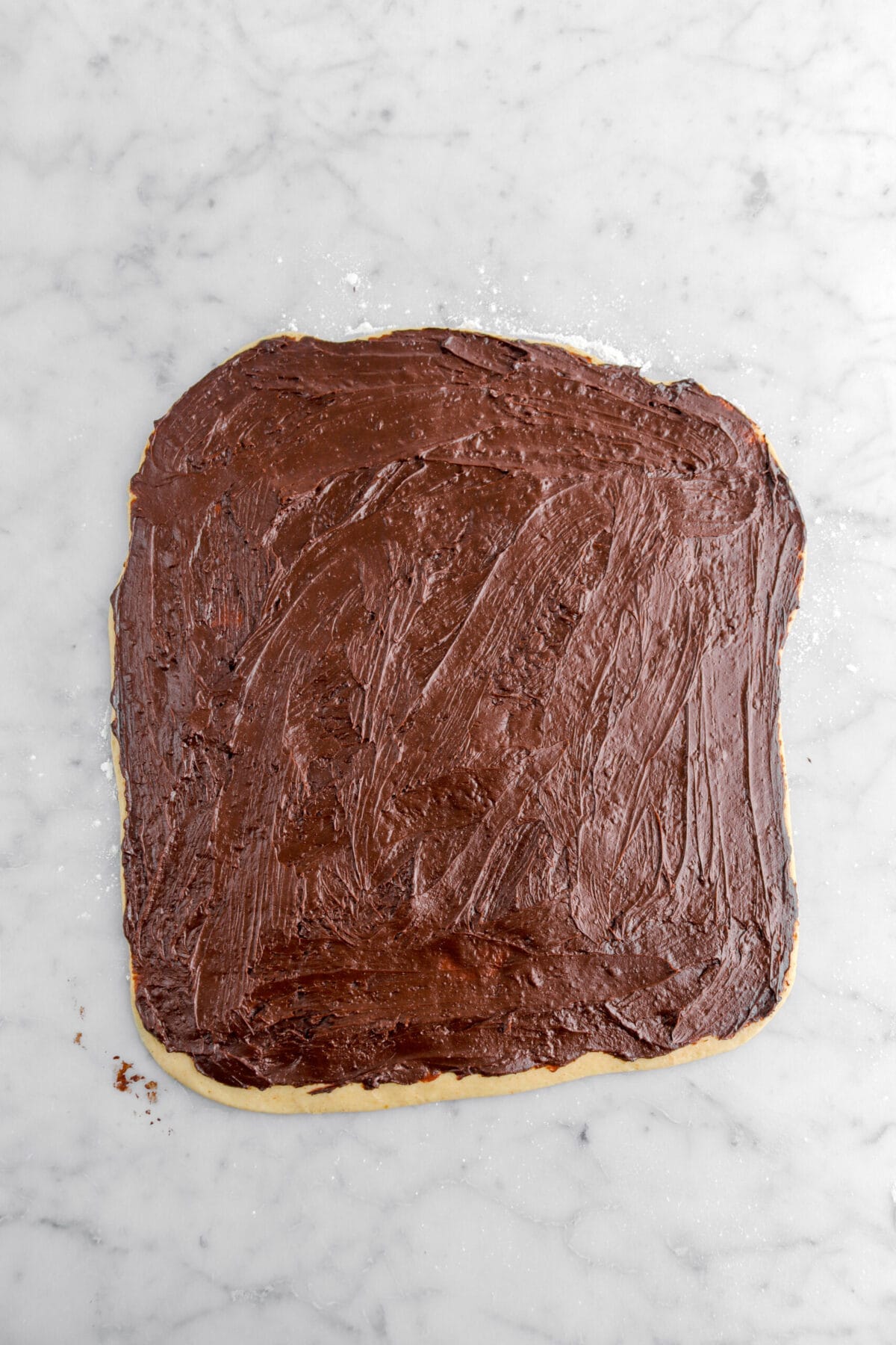 ganache spread across rolled out dough.