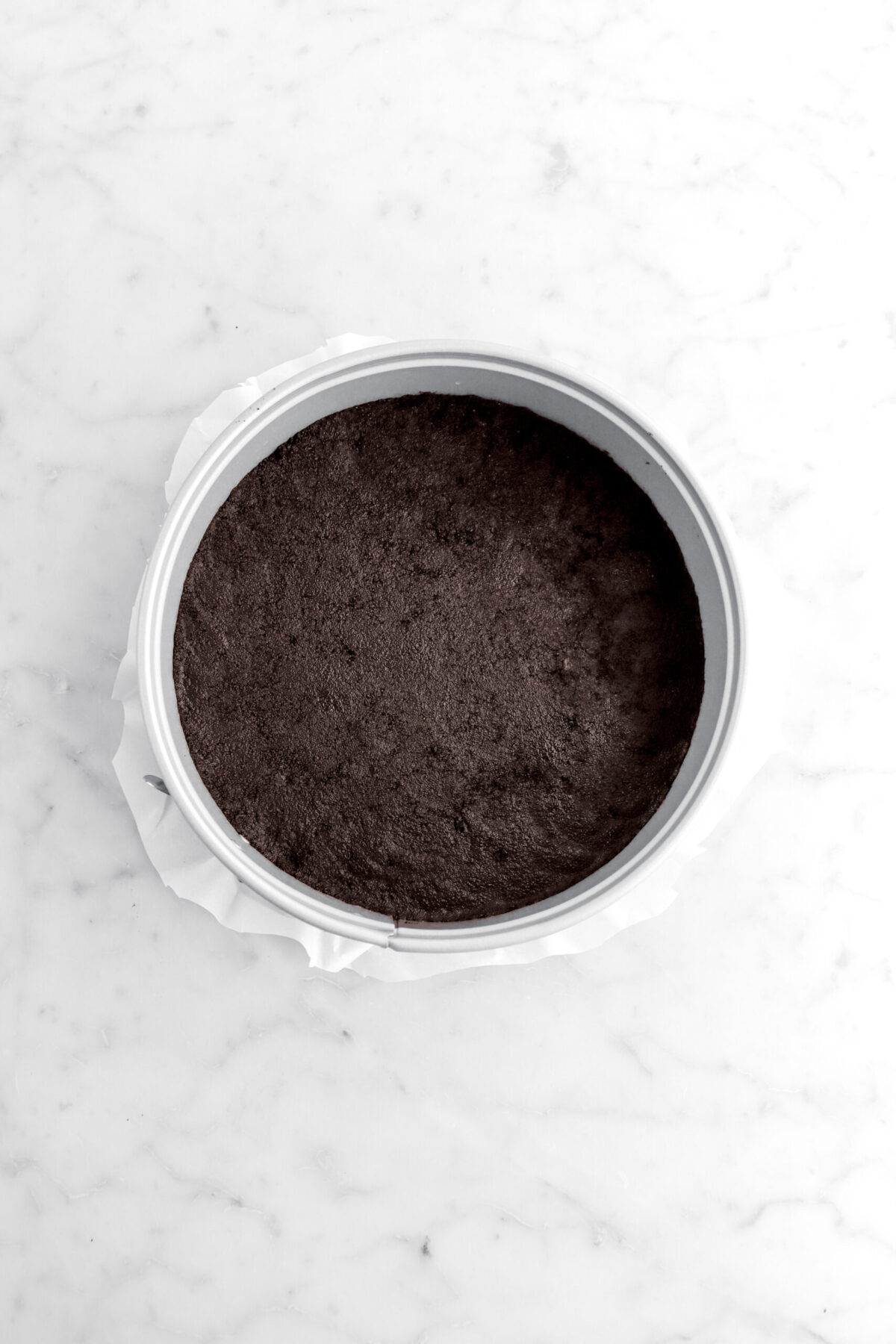 packed oreo crust in spring form pan.