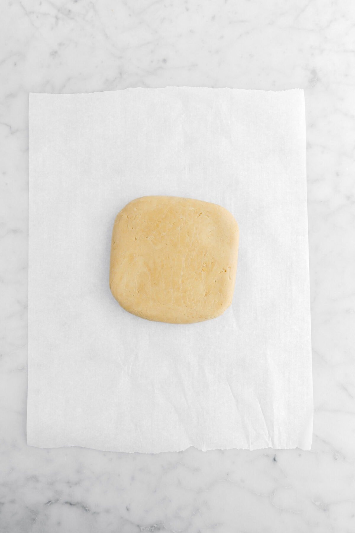 cookie dough in square shape on parchment paper.