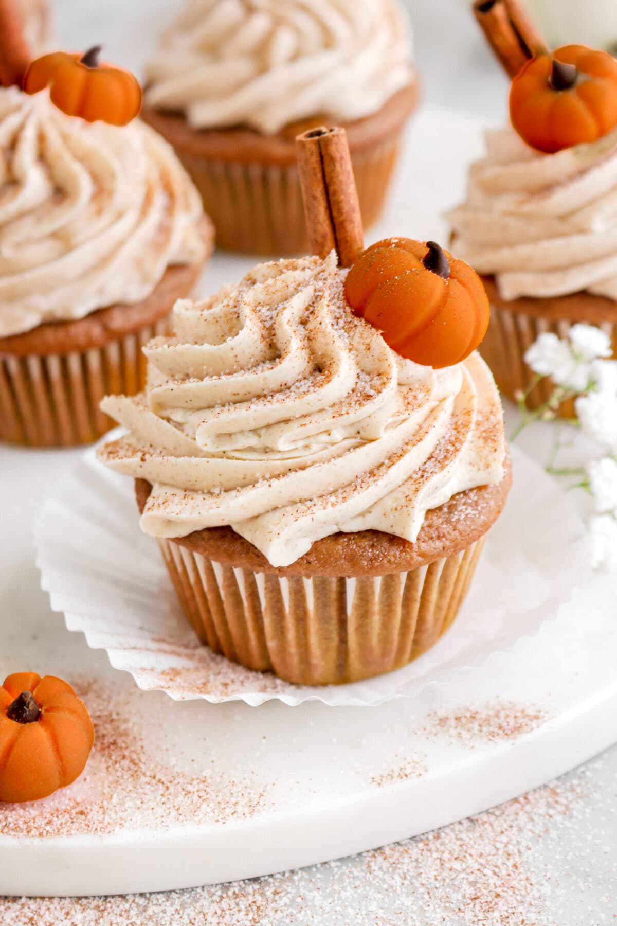 angled close up of frosted pumpkin cupcake.