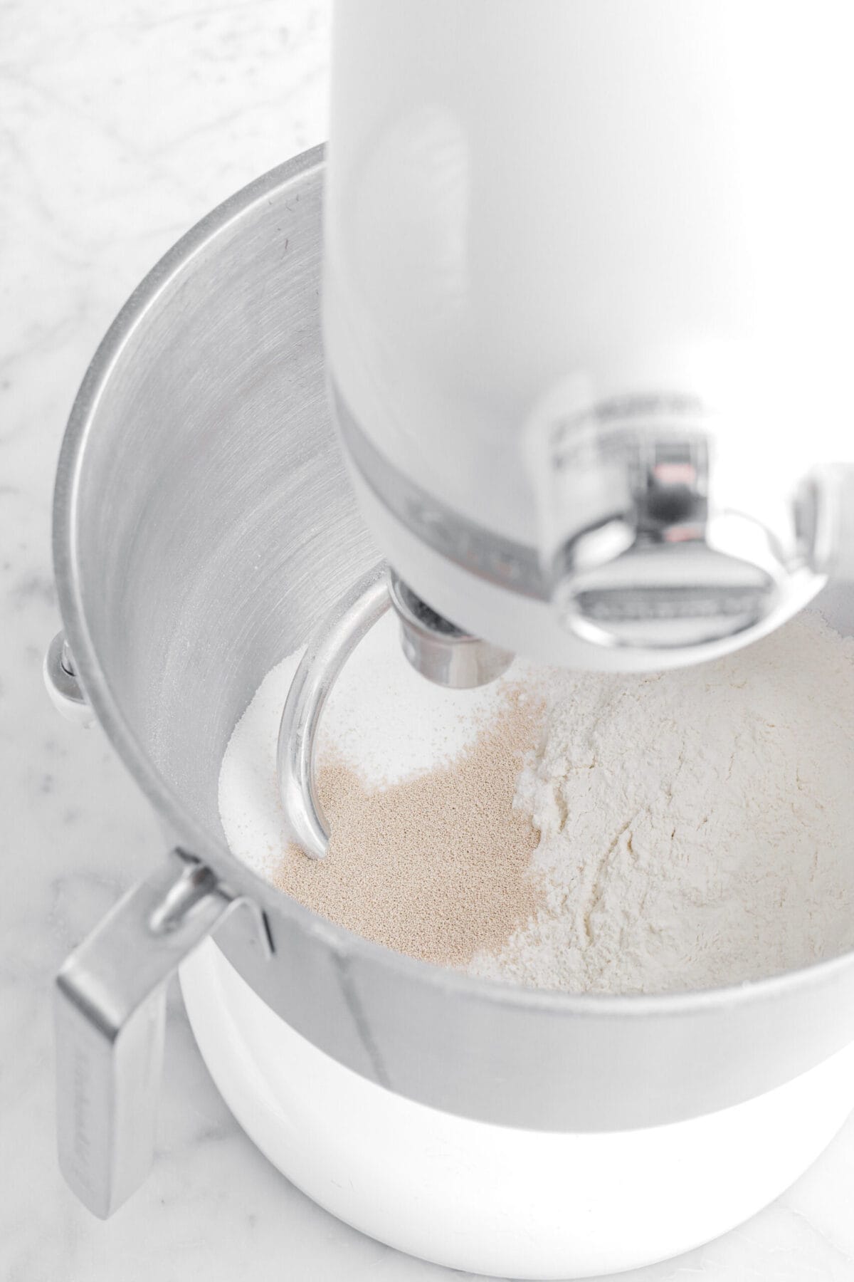 flour, yeast, and sugar in stand mixer.