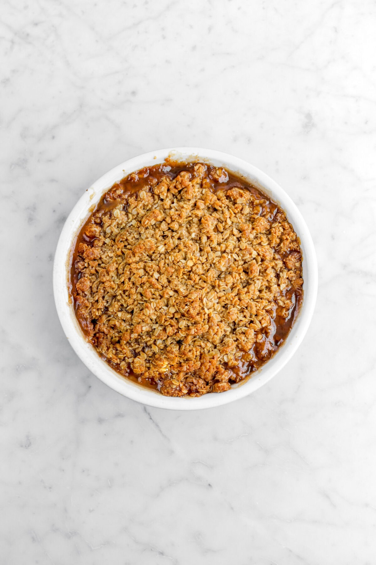 baked pear crisp on marble surface.