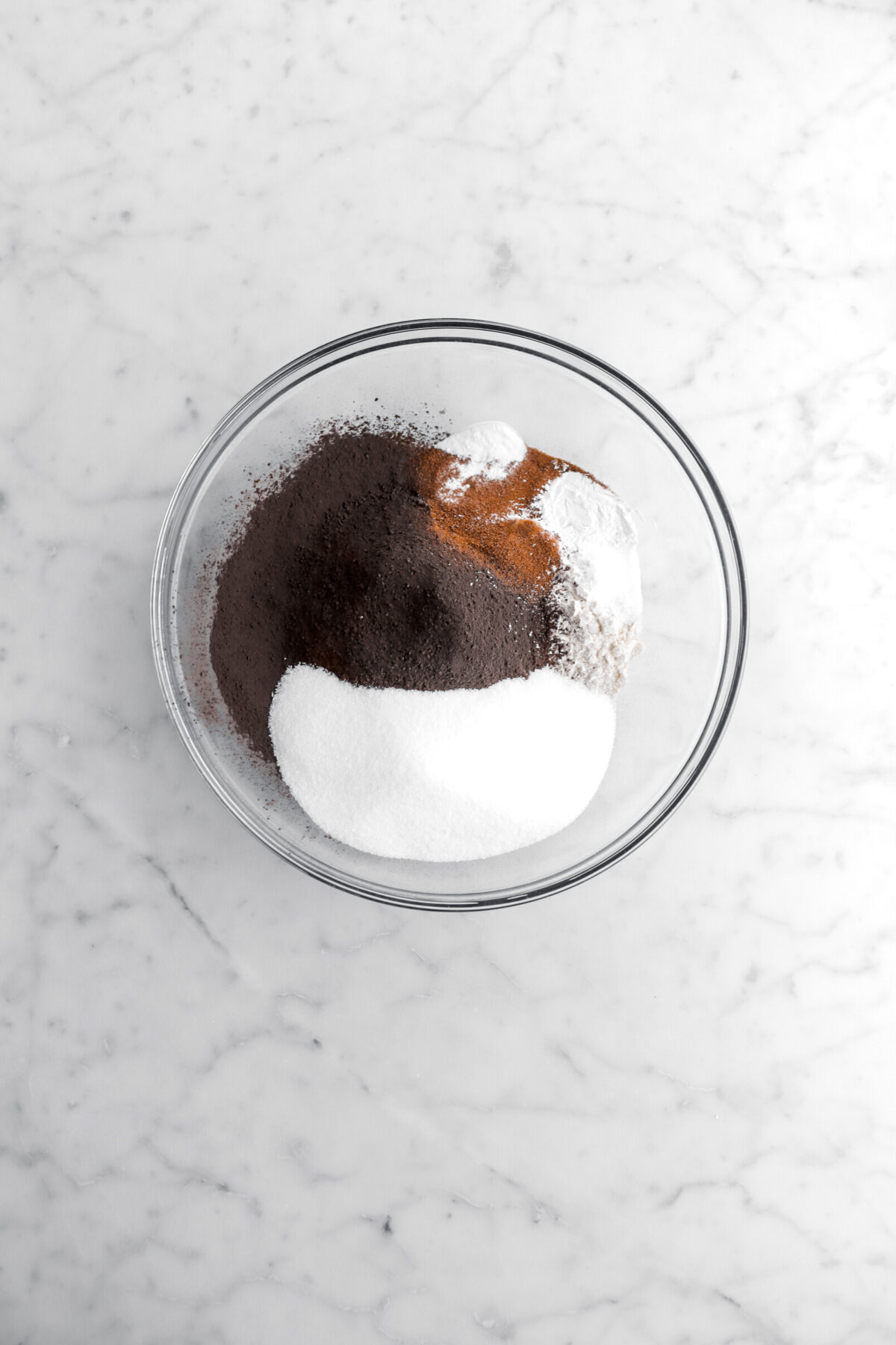 sugar, cocoa powder, flour, leavening, and espresso powder in glass bowl.