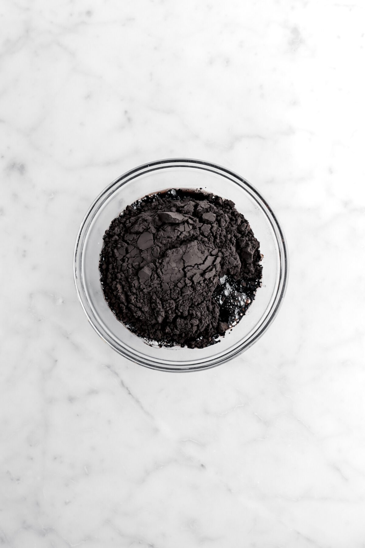 black cocoa powder and water in glass bowl.