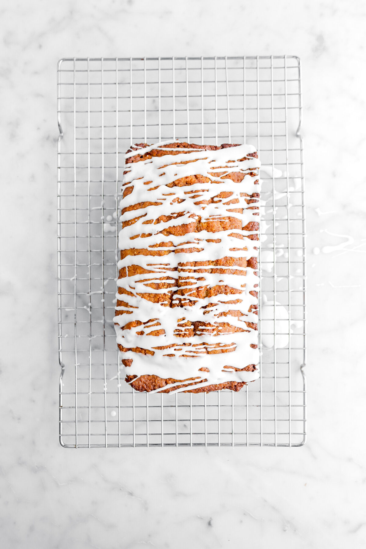 cinnamon swirl bread with icing drizzled over the top.