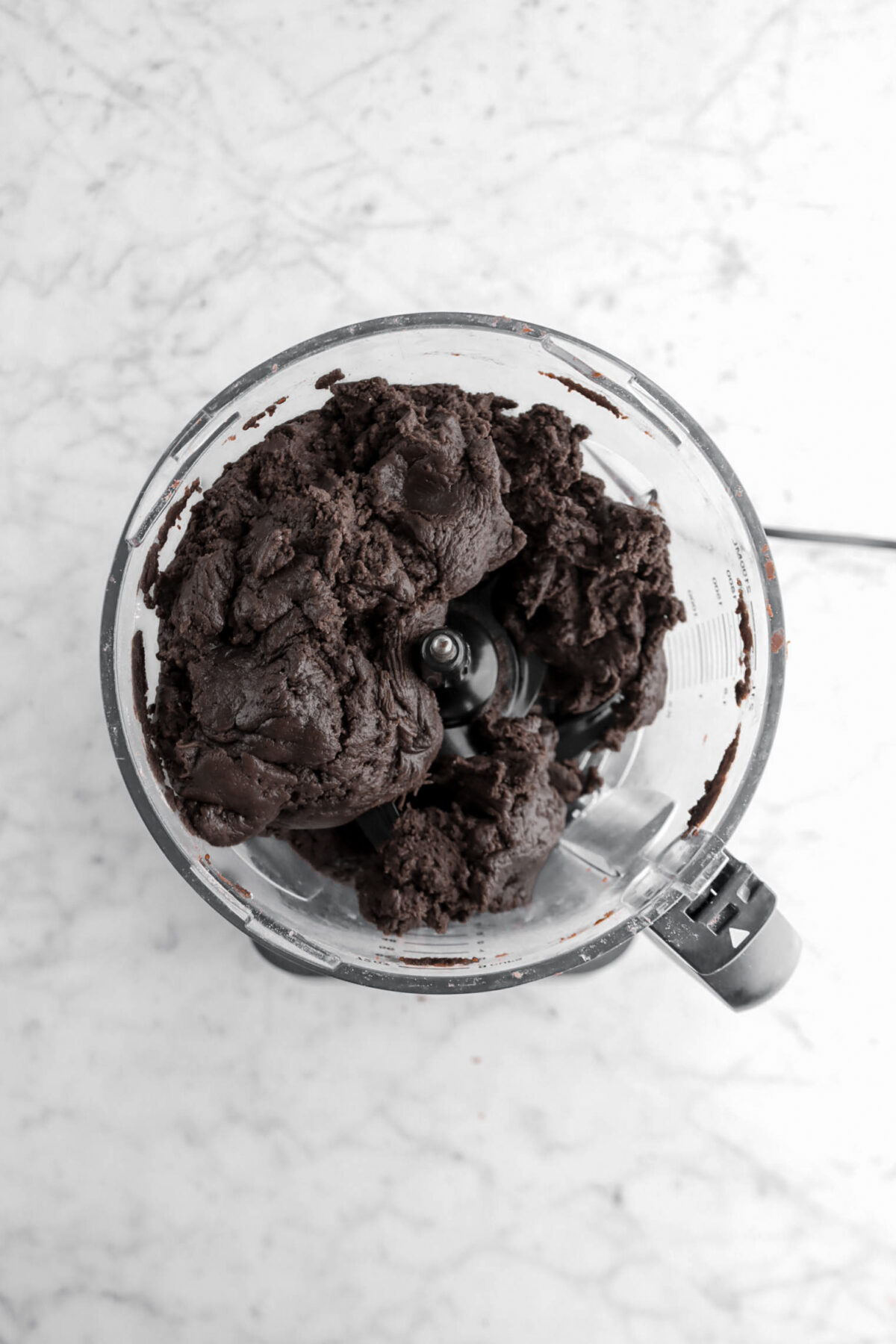 black cocoa dough in food processor.