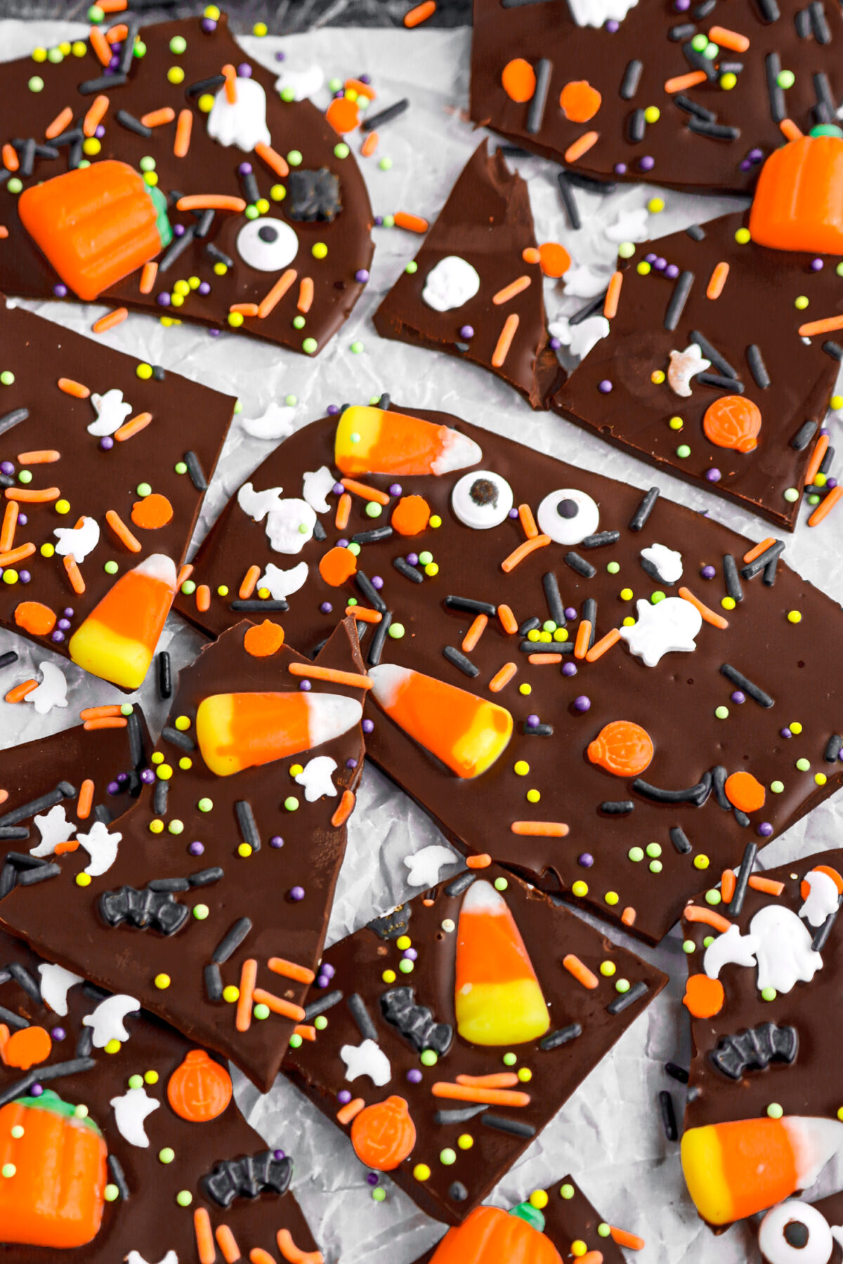 angled image of chocolate halloween candy bark on parchment paper,