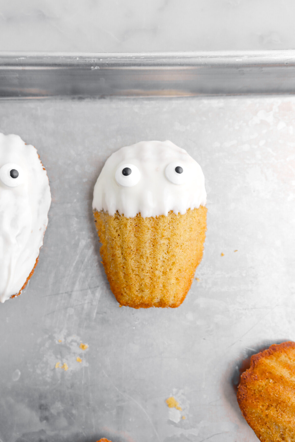 two candy eyes added to white chocolate madeleines.