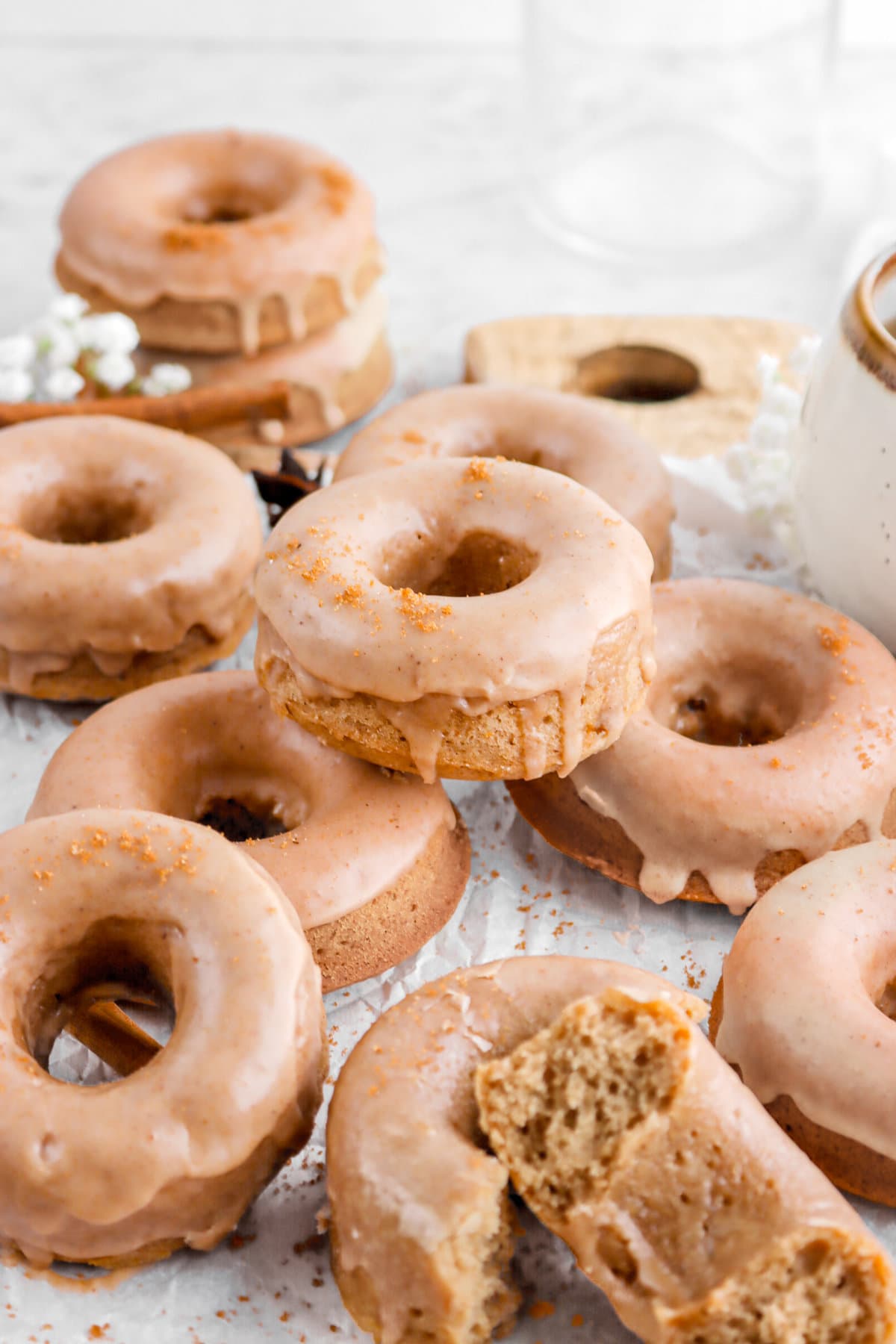 piled baked donuts on parchment paper.