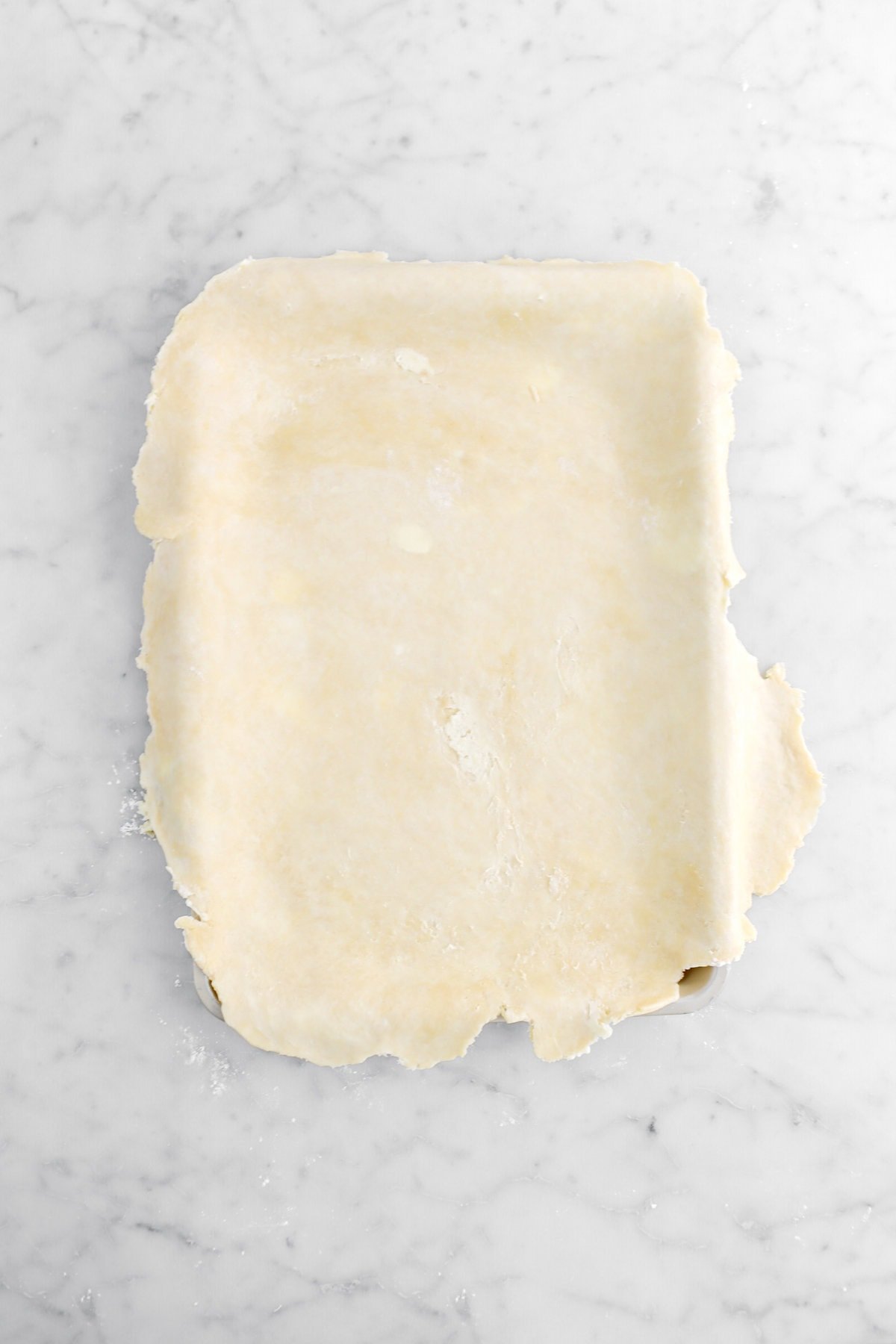 pie dough laid on top of sheet pan.