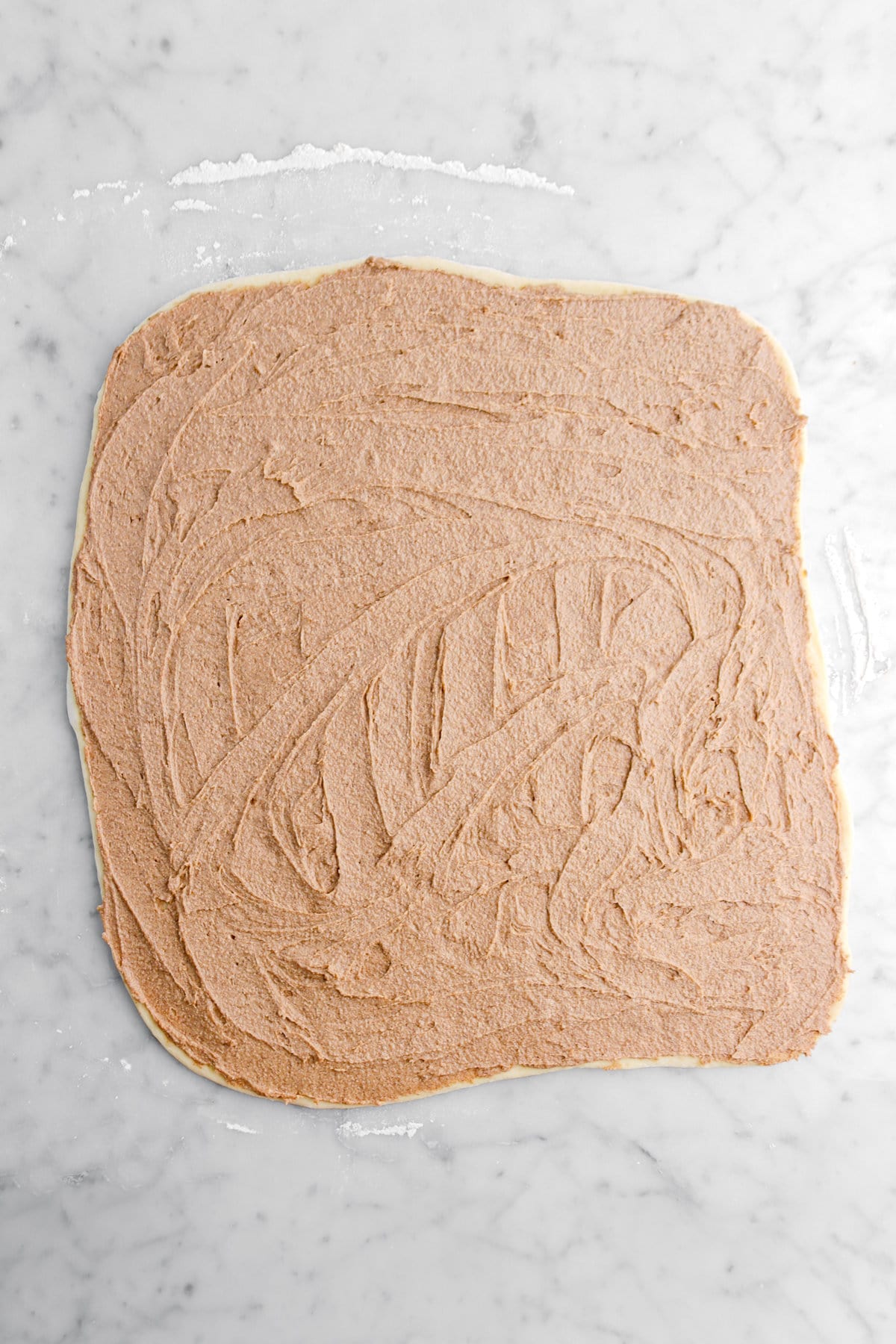 cinnamon butter spread across dough.