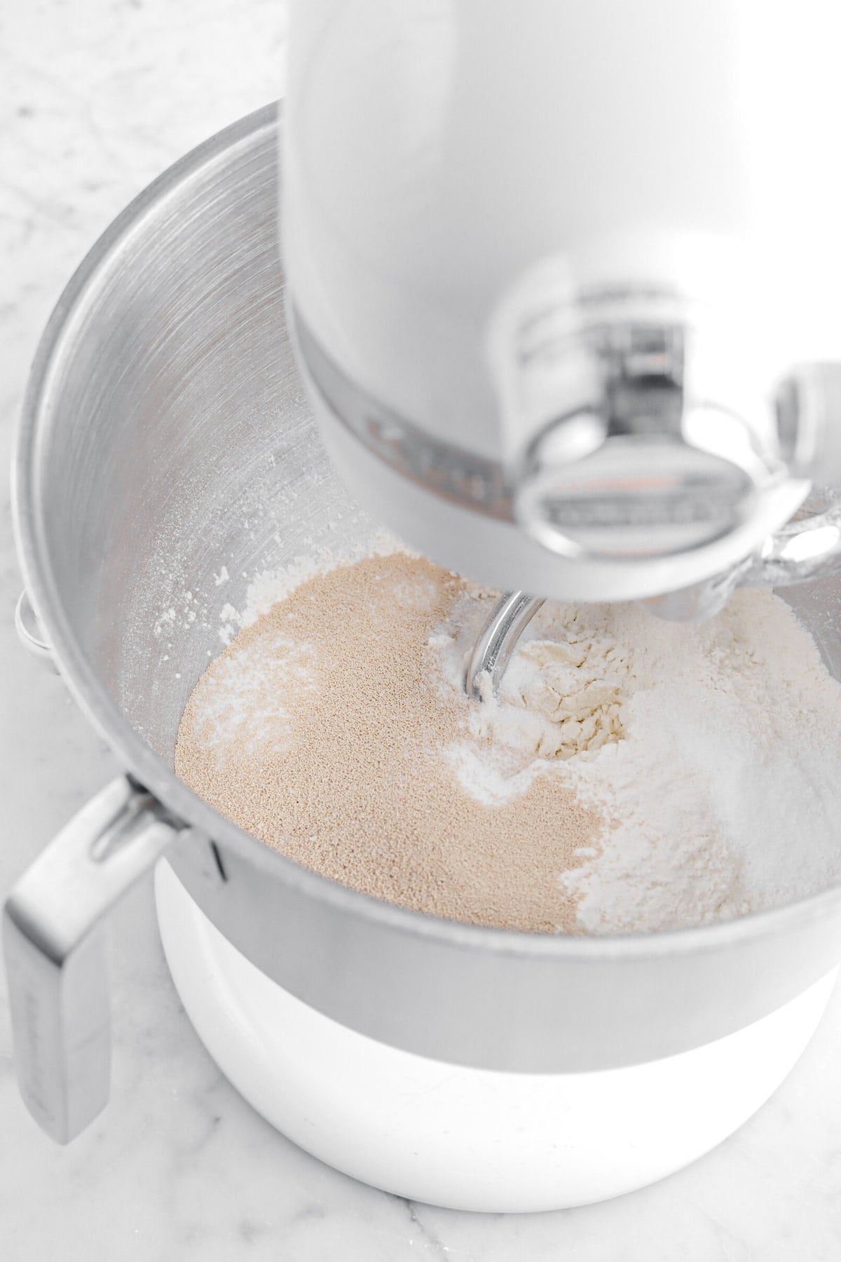 yeast, salt, flour, and sugar in stand mixer.