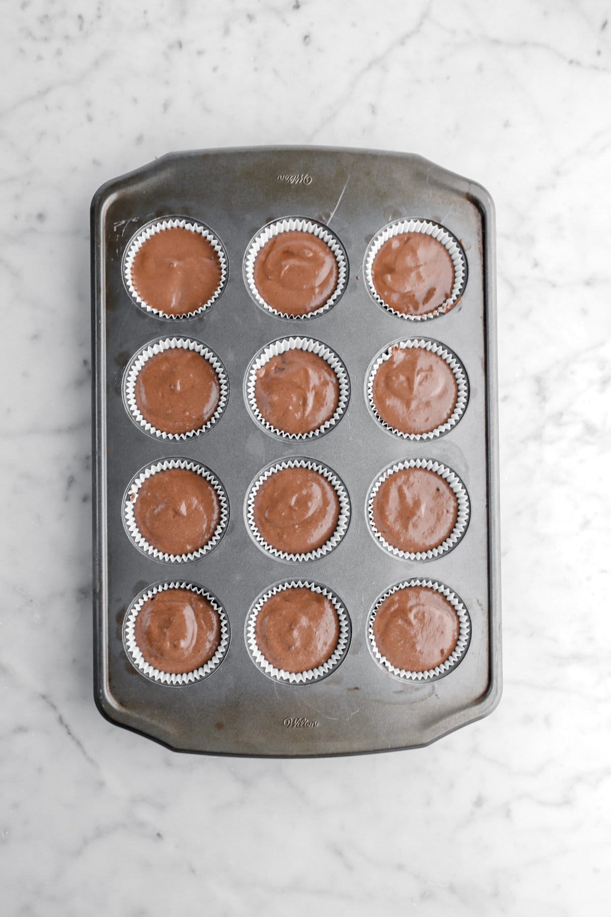 chocolate batter in muff pan.