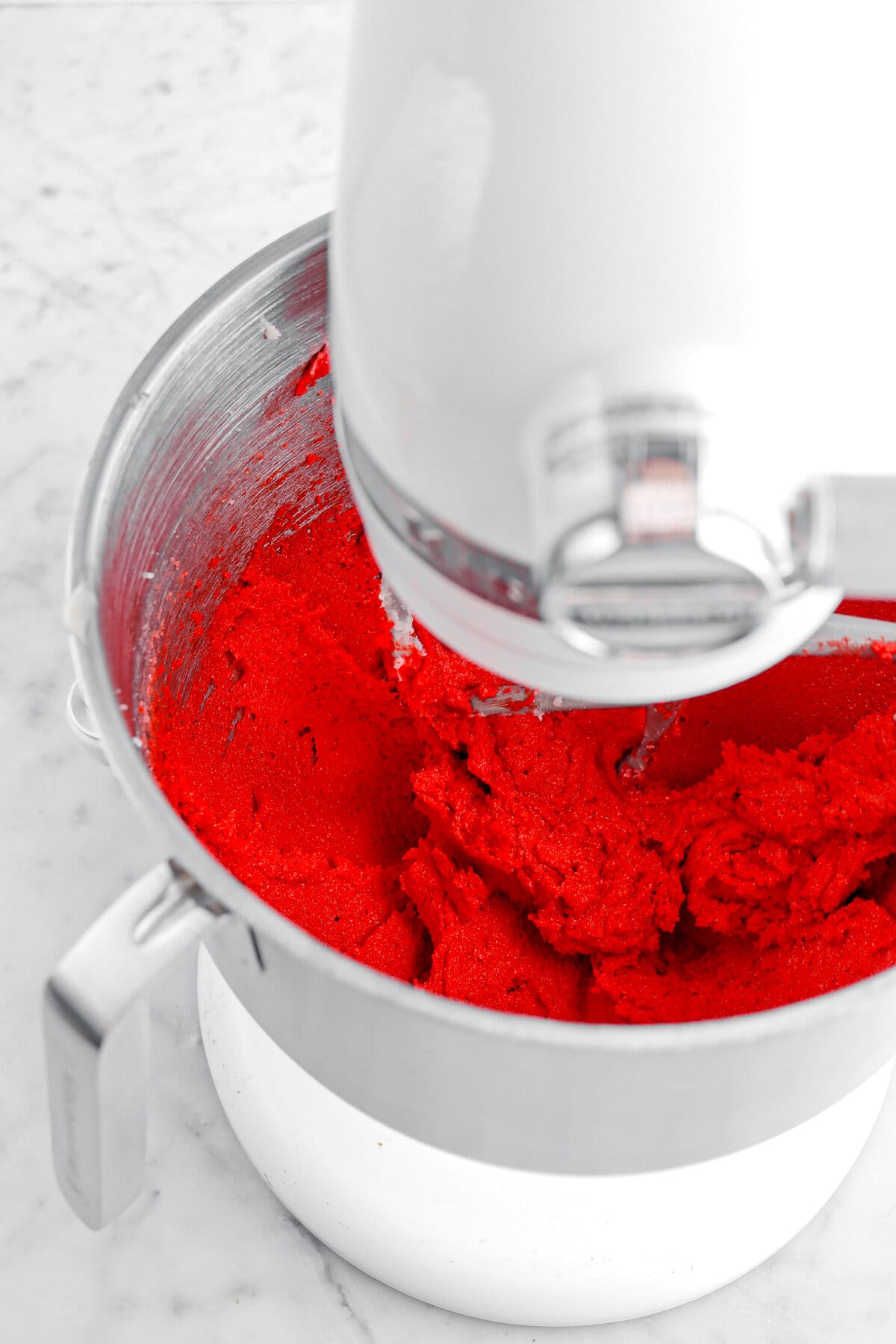 red butter and sugar mixture in stand mixer.