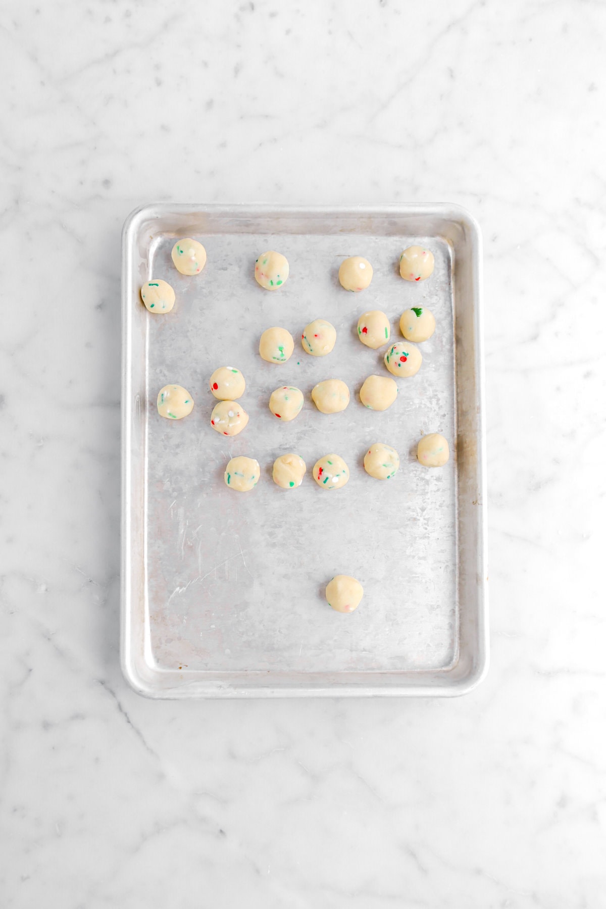 cookie dough balls on small sheet pan.