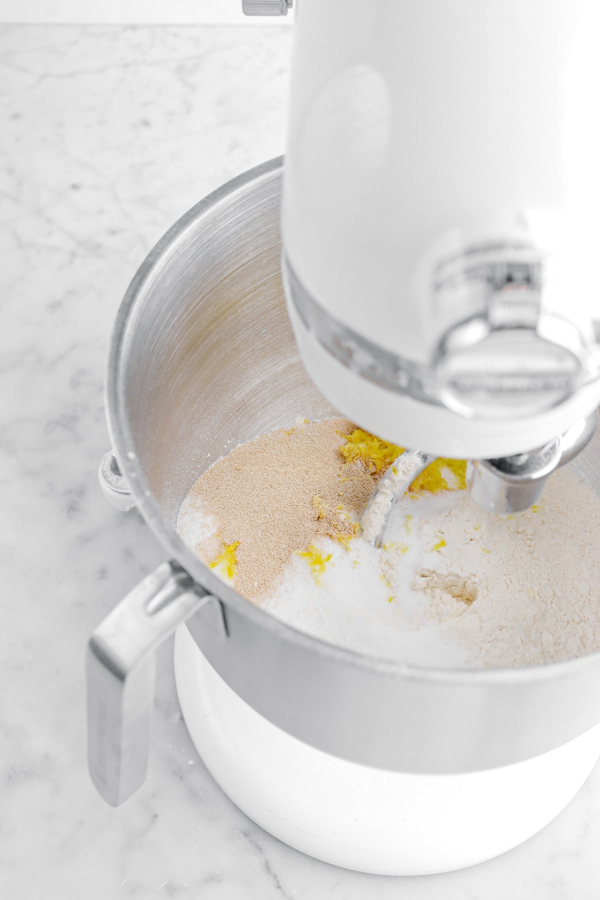 yeast, flour, sugar, and lemon zest in stand mixer.
