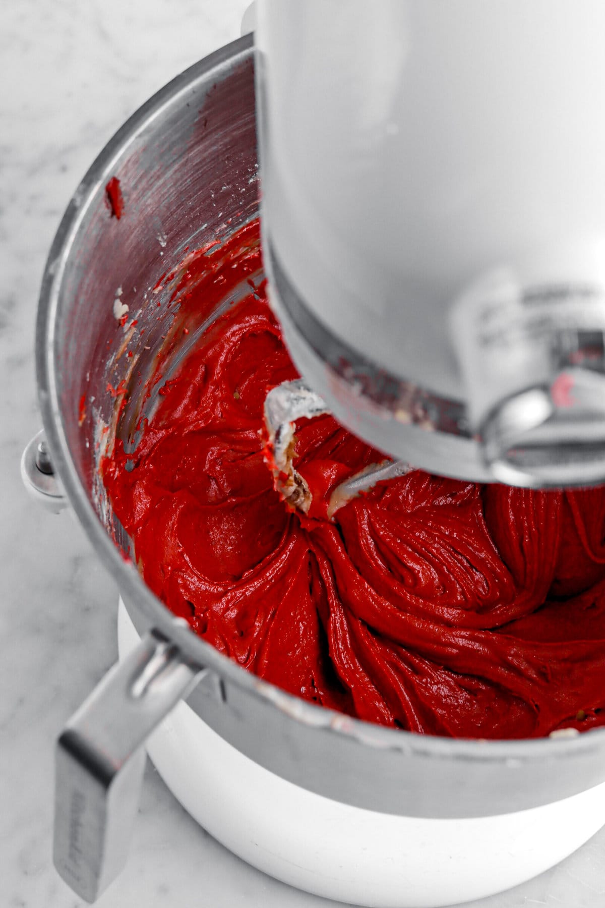 red cake batter in stand mixer.