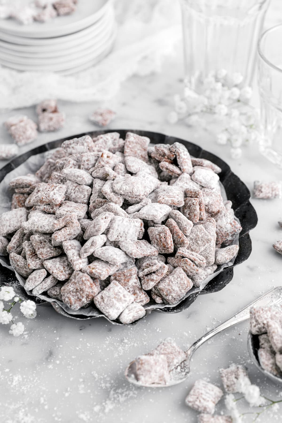 cropped close up of muddy buddies in pie plate with spoon beside.