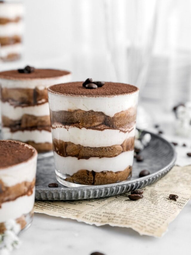 close up of tiramisu cup on metal plate.