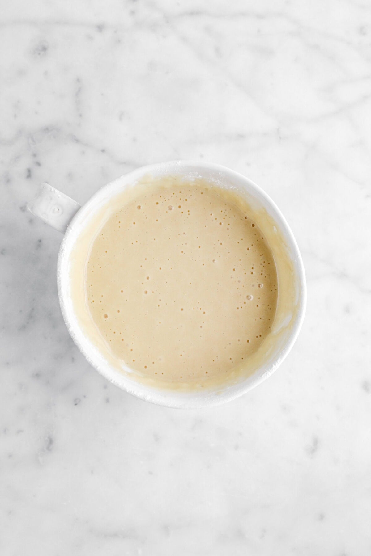cake batter in white mug.