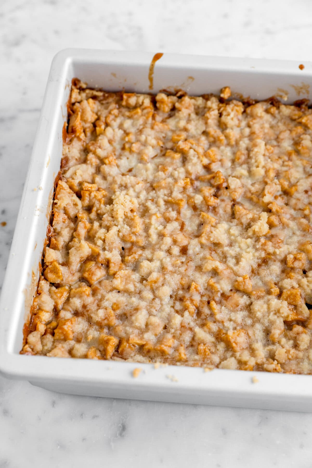 baked apple crumble in square cake pan.